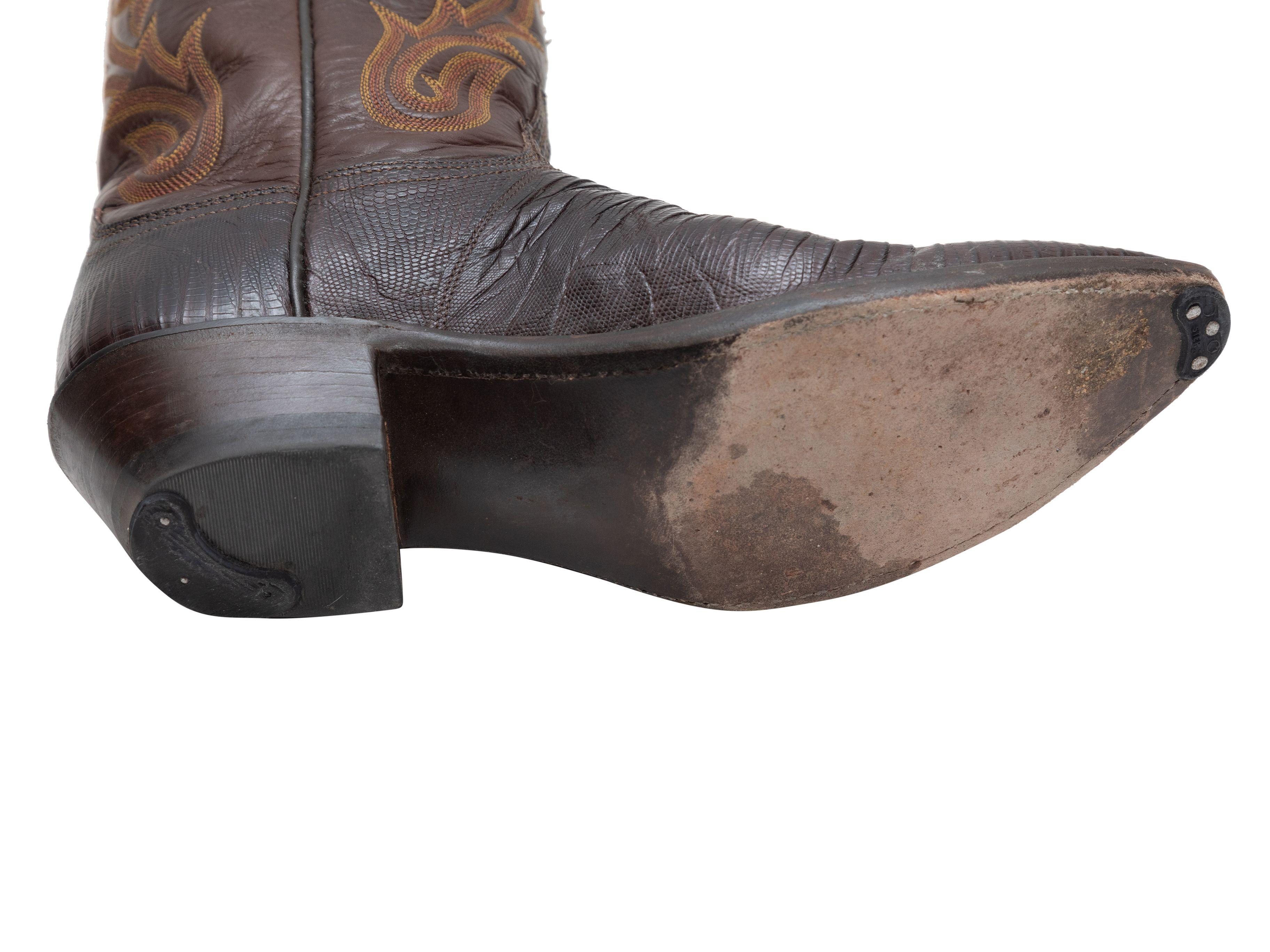 Product Details: Brown embroidered leather and lizard skin pointed-toe cowboy boots by Lucchese. Stacked heels. 2