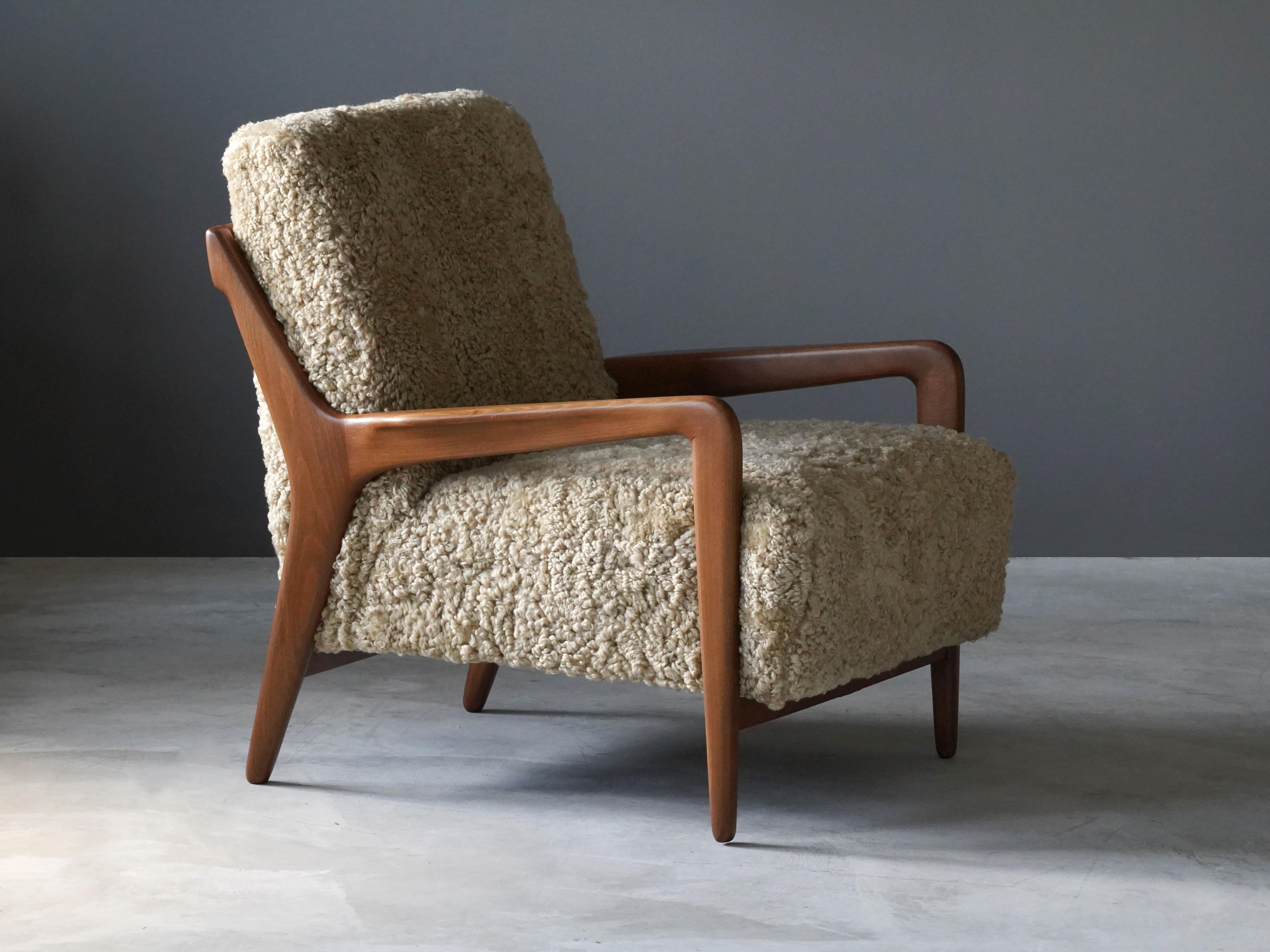 A lounge chair produced by Lucchini & Lissone, Italy, 1950s. The organically sculpted beech frame is paired with the overstuffed seat, with its softness further enhanced by sheepskin upholstery. 

Other identical examples have been uncovered bearing