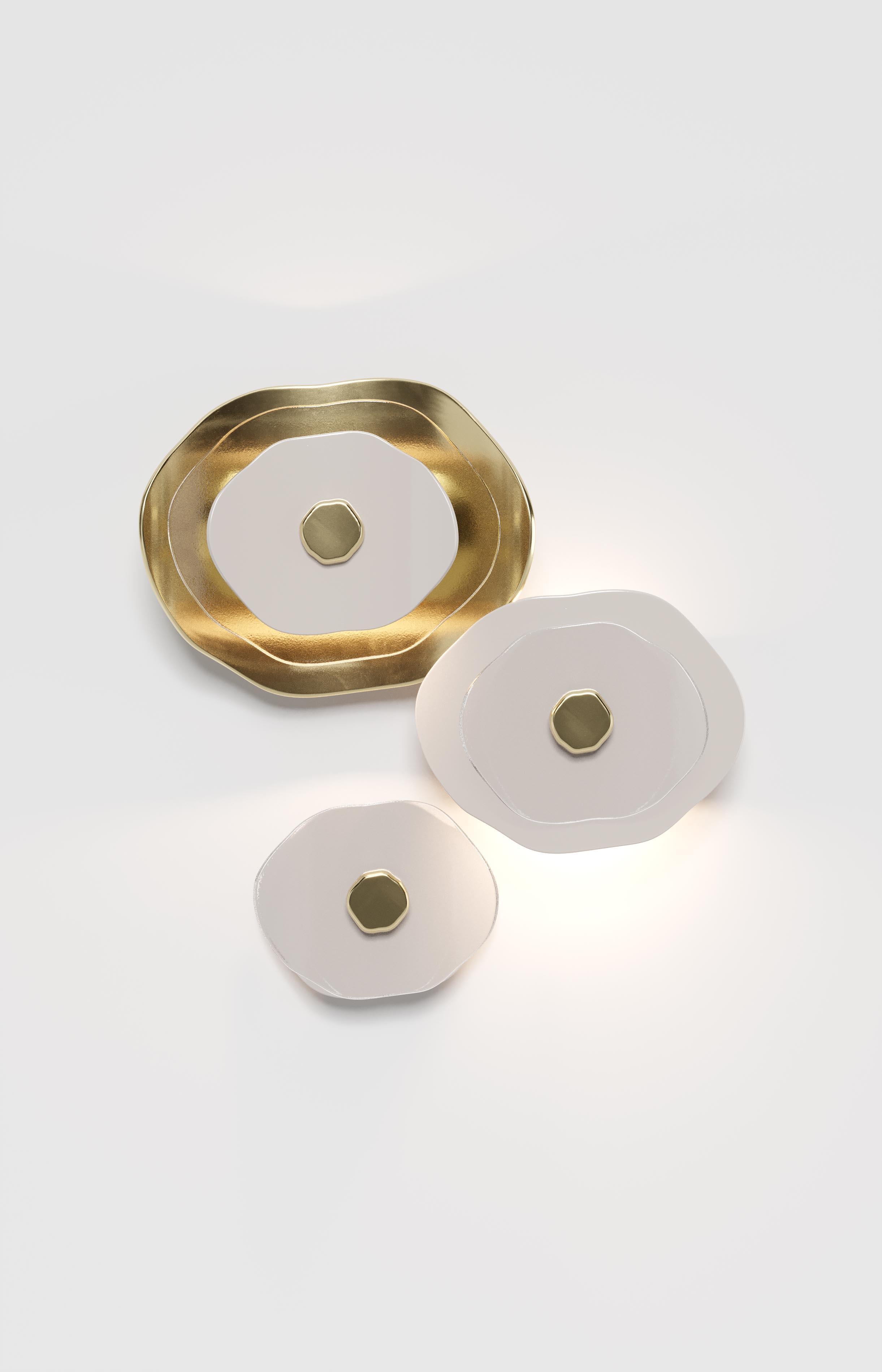 Wall composition of three flower elements (two with light, one decorative). Petals in clear glass, polished light gold and polished white finish; metal hardware in polished light gold. 

No. 2 flower-elements with LED module for upper and lower