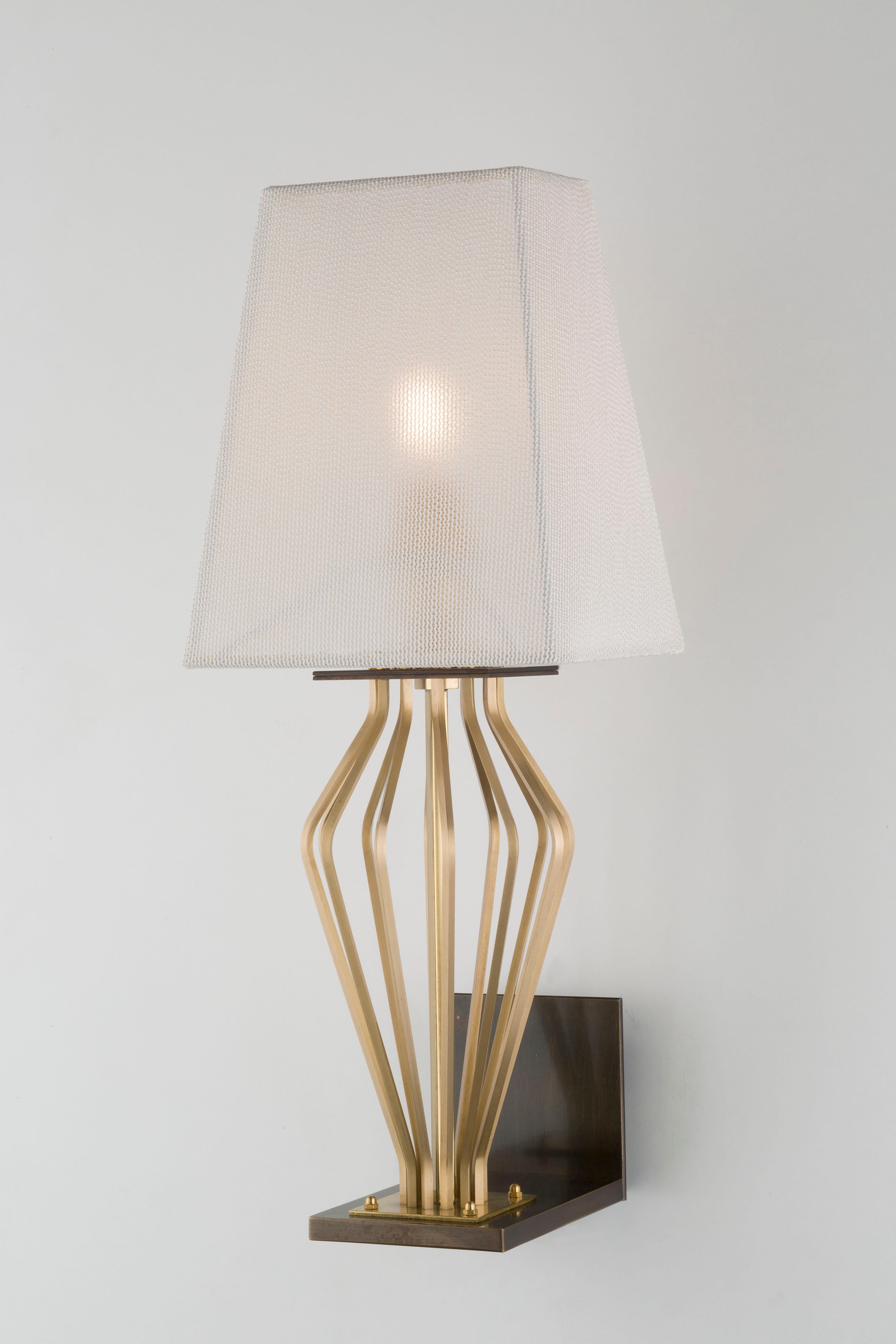 SABA Collection  Solid brass faceted rods harmoniously bend outwards, in various choreographies.
Structure in natural brass; base in burnished finish. Shade in ivory trevira wave fabric.

1 x E12/14; CE/UL certified.