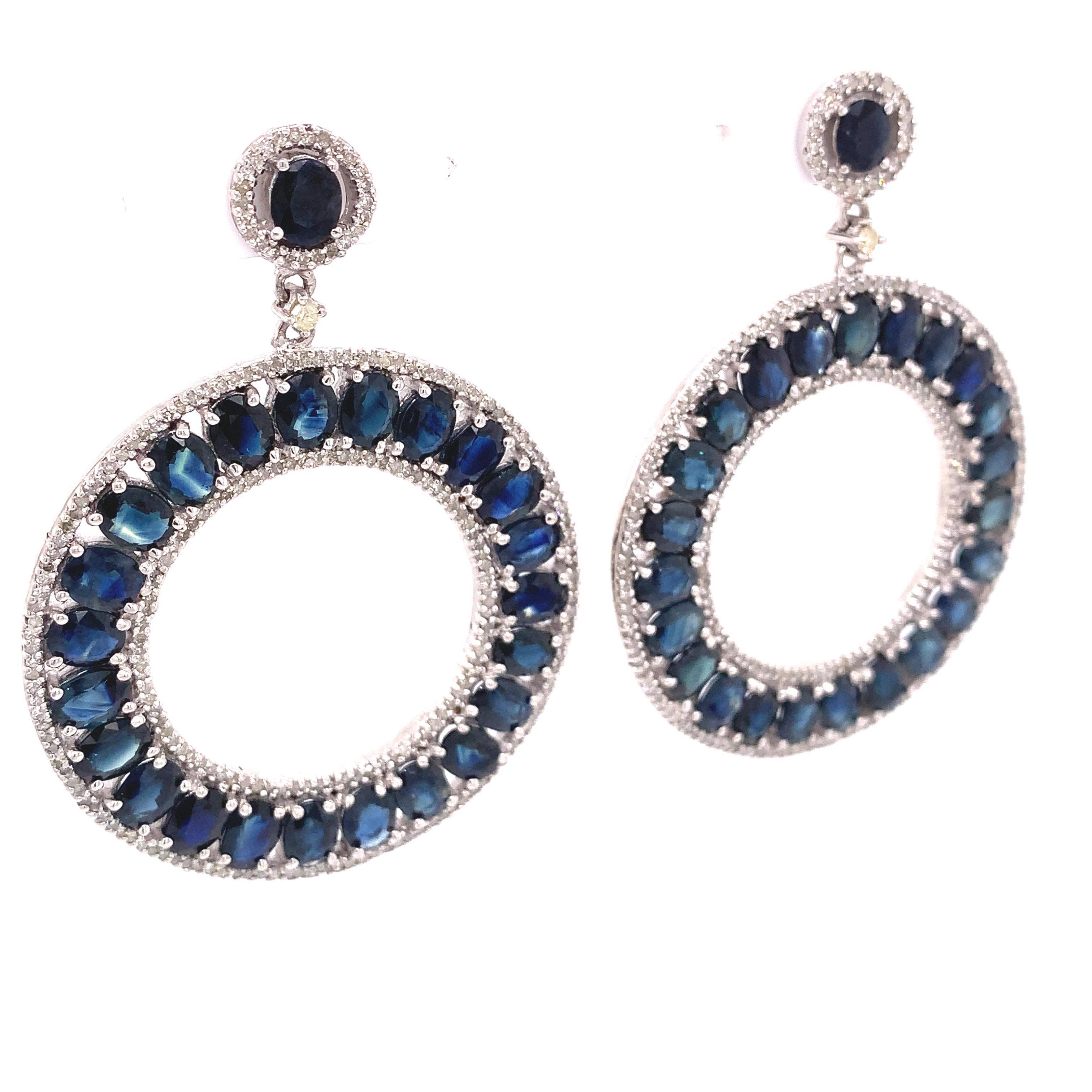 Life In Color Collection 

Blue Sapphires and accent Diamonds in these drop circle earrings set in sterling silver and 14K gold plated.

Blue Sapphire: 20.50ct total weight.
Diamonds: 2.01ct total weight.