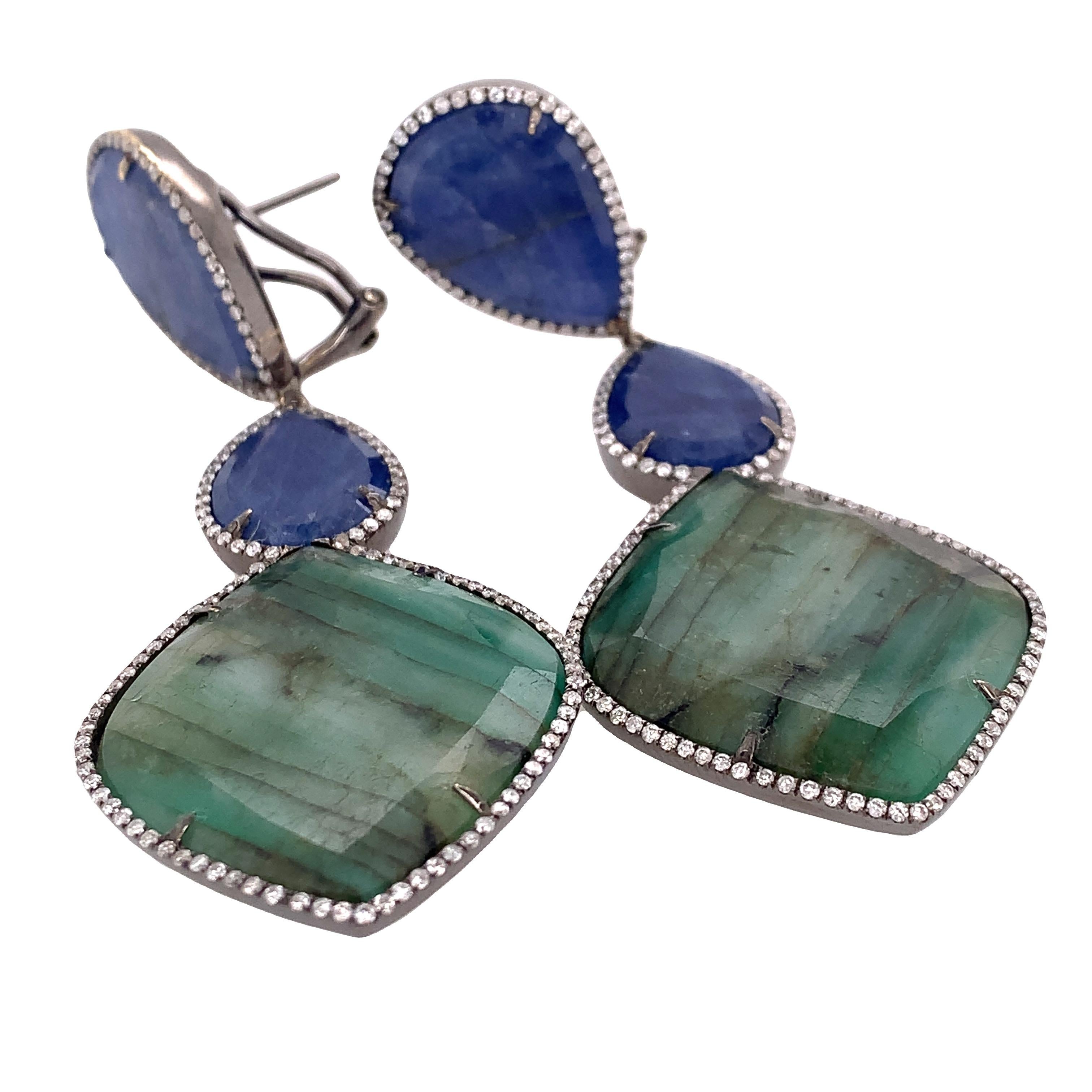 Lillipad Collection

Blue Sapphire and Emerald are wrapped by Diamond feature as dangling earrings set in 18k black gold. All gemstones are natural slice.

Blue Sapphire: 29.33ct total weight.
Emerald: 30.92ct total weight.
Diamond: 1.17ct total