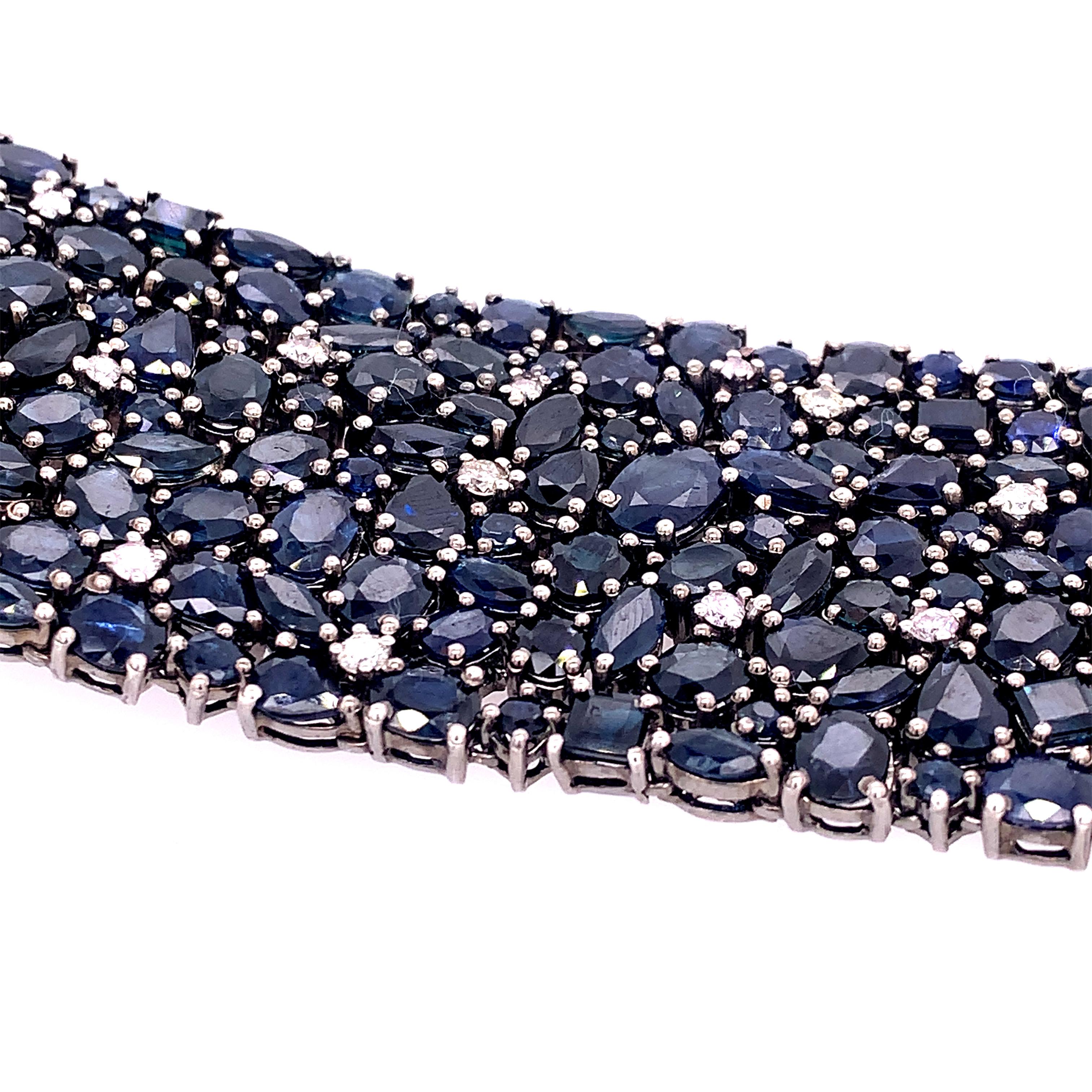 Life In Color Collection 

Mixed cut blue Sapphire statement bracelet with Diamond accents set in darkened sterling silver. 

Blue Sapphire:101.85:ct total weight. 
Diamonds: 1.38ct total weight.

.