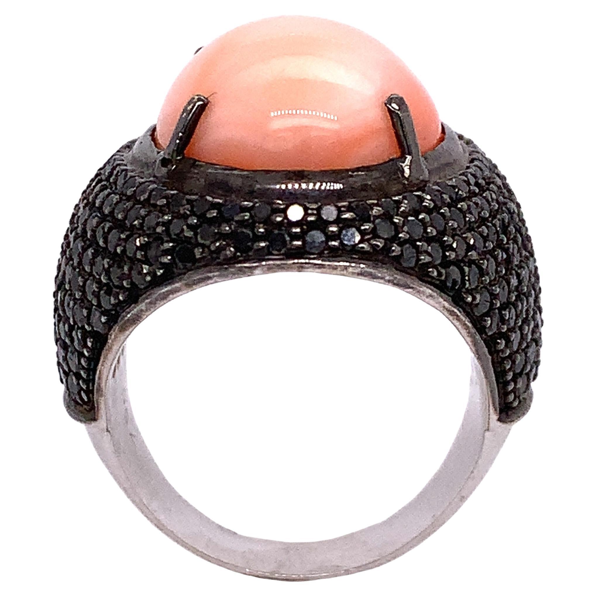 Exclusive Collection

This beautiful Coral surrounded by Black Diamond ring features a unique design that is both fashionable and simple. This stunning piece of cocktail ring set in 18K white gold and it's part of the high-end jewelry from our