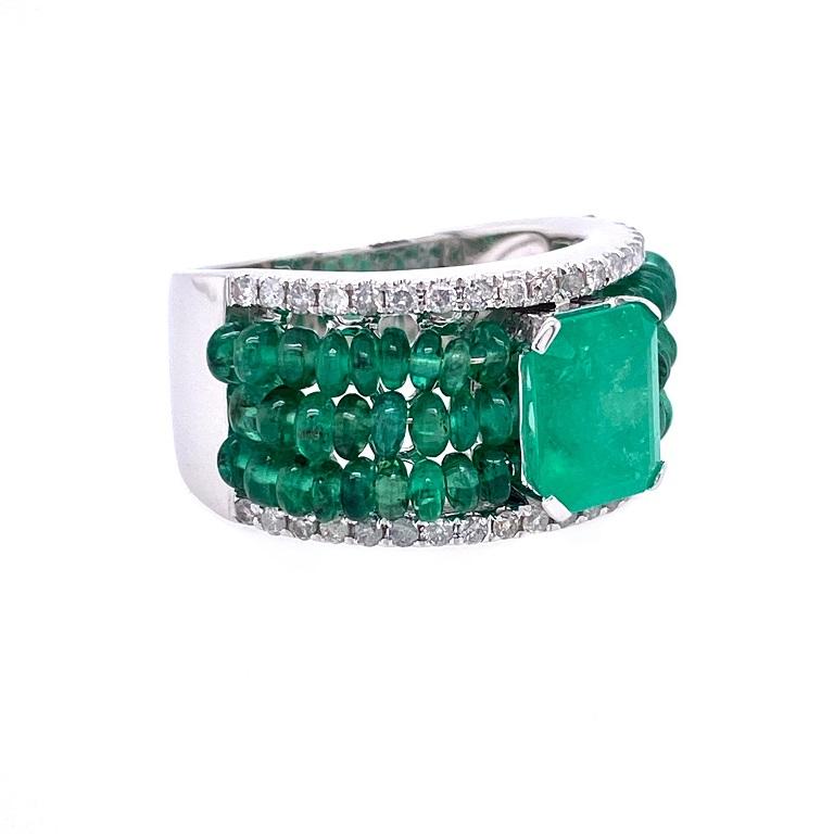 Evergreen Collection 

Emerald cut Emerald center stone with three rows of Emerald beads and Diamond accents set in solid 18K white gold. US size 6.

Full Cut Emerald: 1.88ct total weight. 
Emerald Beads: 3.57ct total weight. 
Diamonds: 0.35ct total
