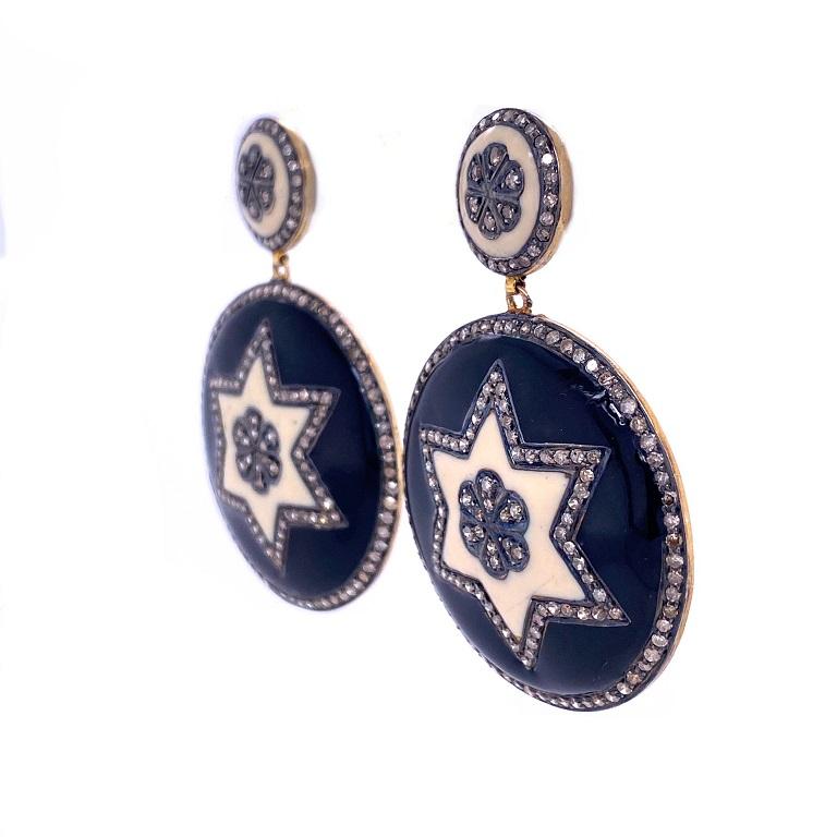 Rustic Collection

Perfect contrast in these black and ivory toned Enamel and rustic Diamond disc shaped earrings with star and flower motif set in sterling silver and 14K gold plating.

Diamonds: 4.26ct total weight.