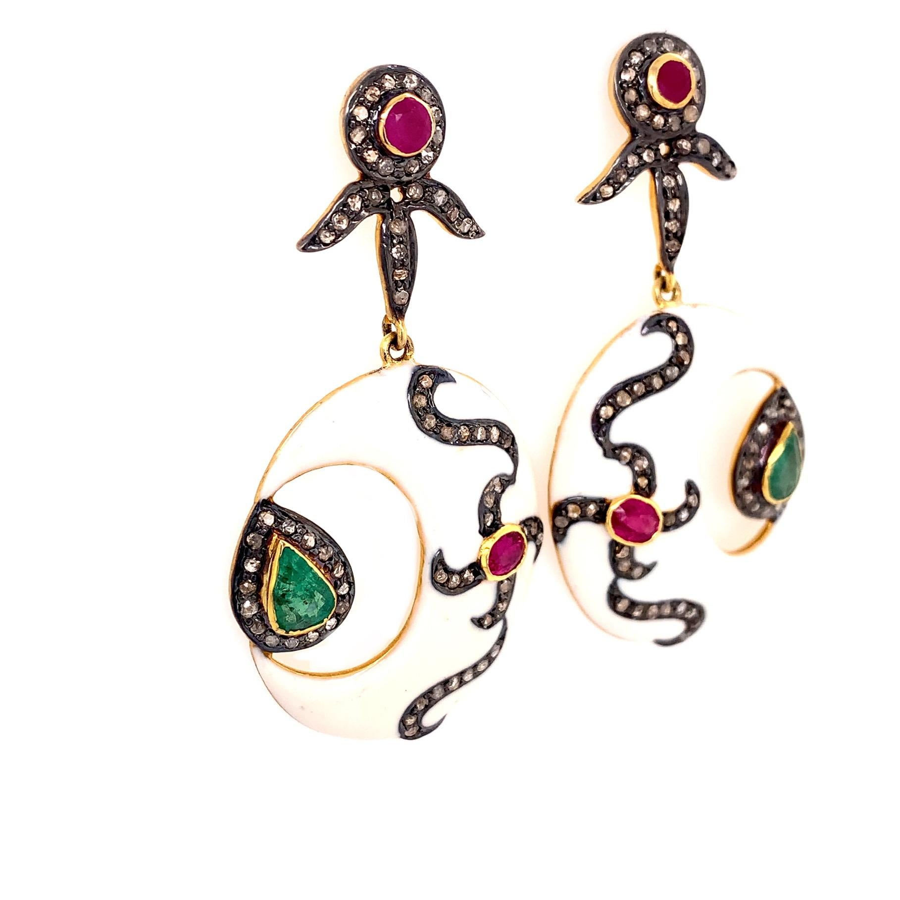 Rustic Collection

Perfect contrast in these black and ivory toned Enamel and rustic Diamond crescent moon tear drop shaped earrings with ruby and emerald set in sterling silver and 14K gold plating to create motifs.

Emerald: 1.07ct total