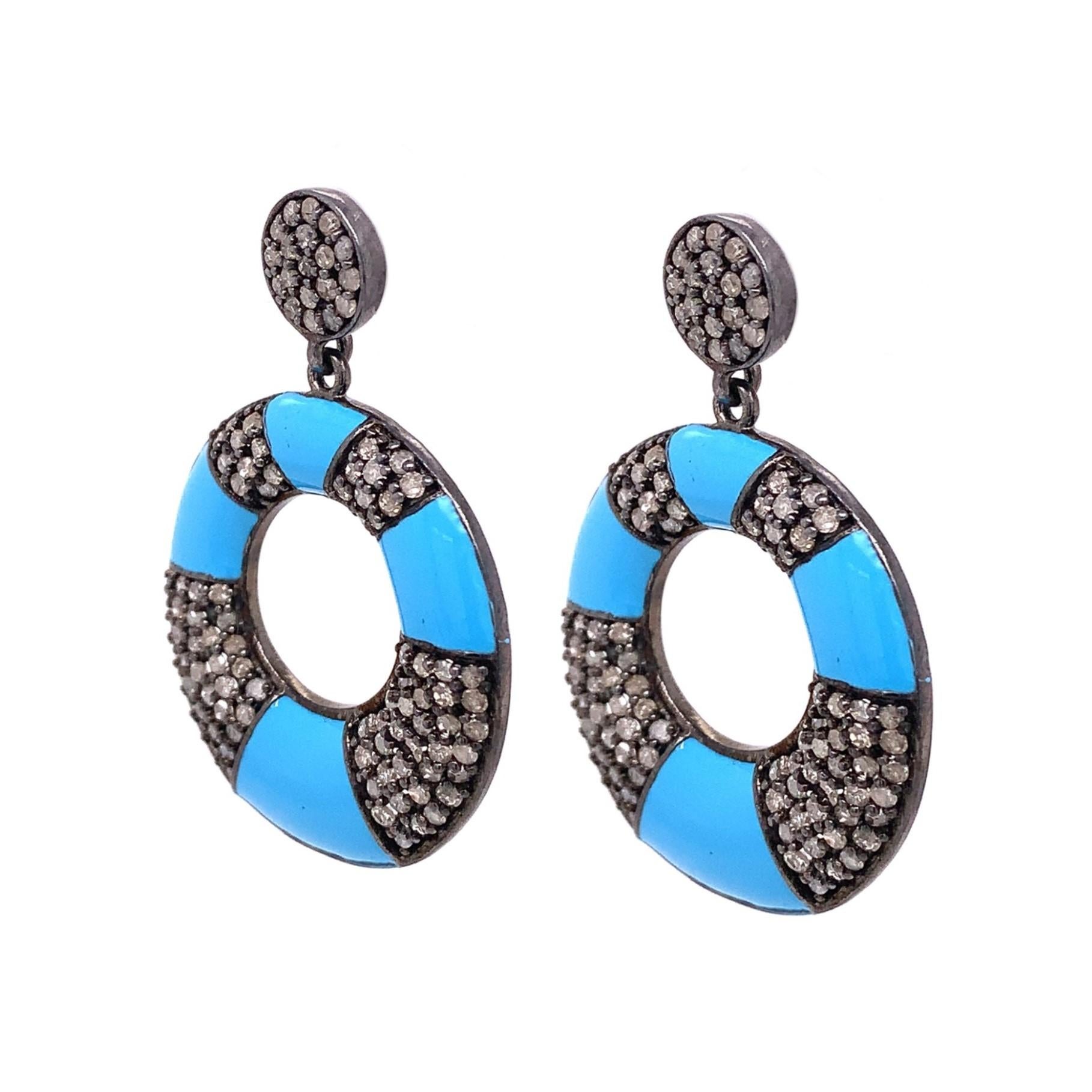 Life in color Collection

Bright  blue turquoise Enamel with icy Diamonds set in blackened Sterling Silver to create one of a kind frontal dangle earrings.

