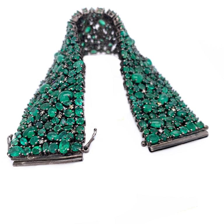Evergreen Collection

A brilliant mixed cut Emerald statement bracelet with Diamond accents set in darkened sterling silver. 

Emerald: 57.42ct total weight. 
Diamonds: 0.83ct total weight.
