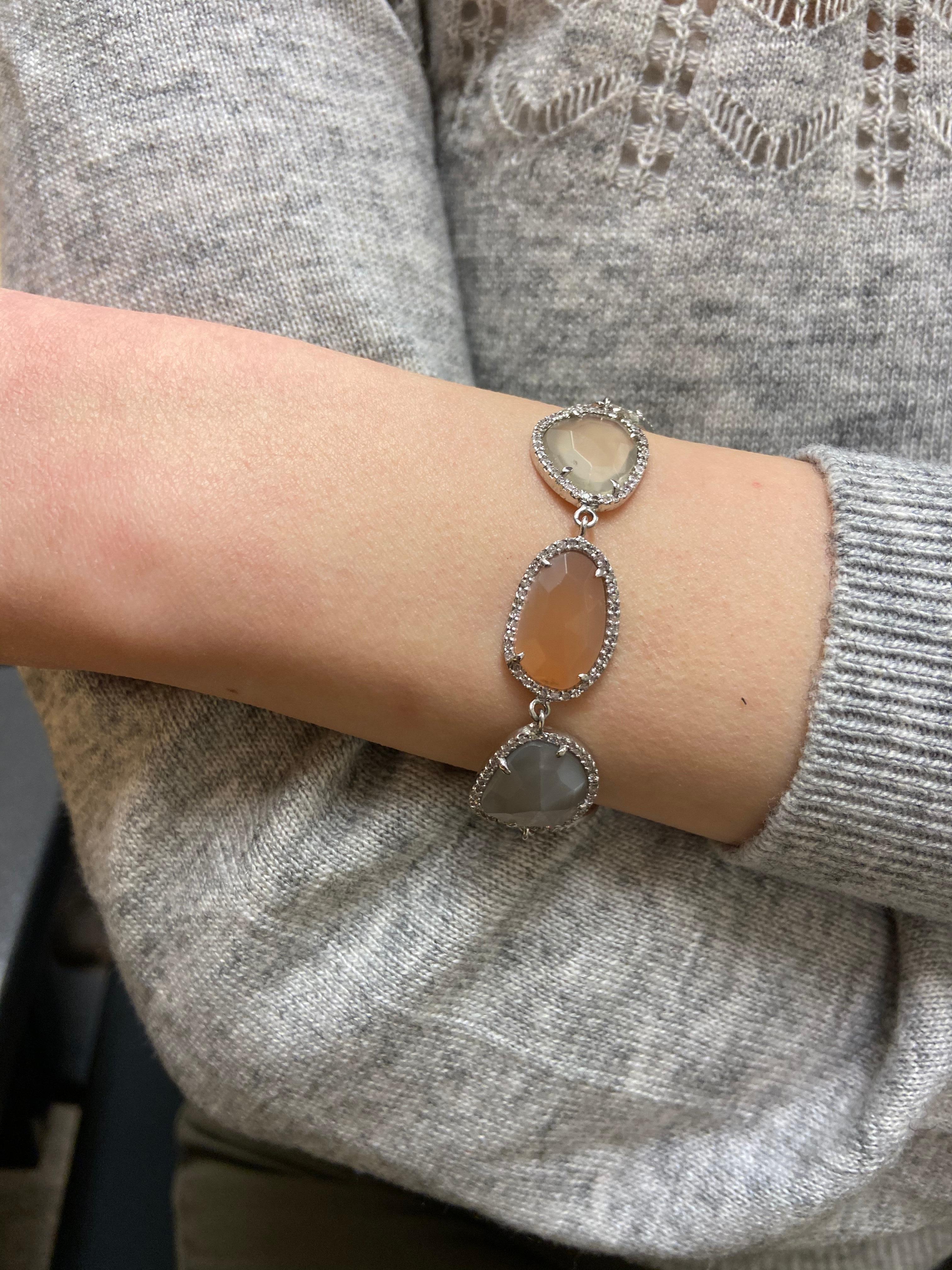 Life In Color Collection 

Colorful and dainty multi colored rose cut Moon stone bracelet enhanced with Diamond pave set in sterling silver.

Moon stone: 48.57ct total weight.
Diamond: 2.15ct total weight.