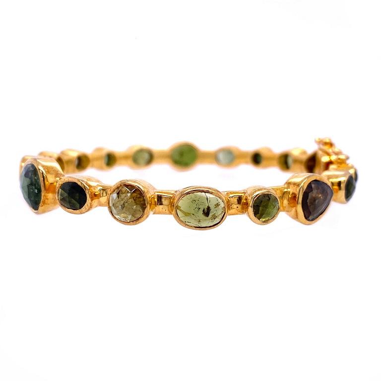 Evergreen Collection

Mixed shape green Tourmaline bangle bracelet set in sterling silver and 14K gold plating. 

Green Tourmaline: 16.66ct total weight. 
