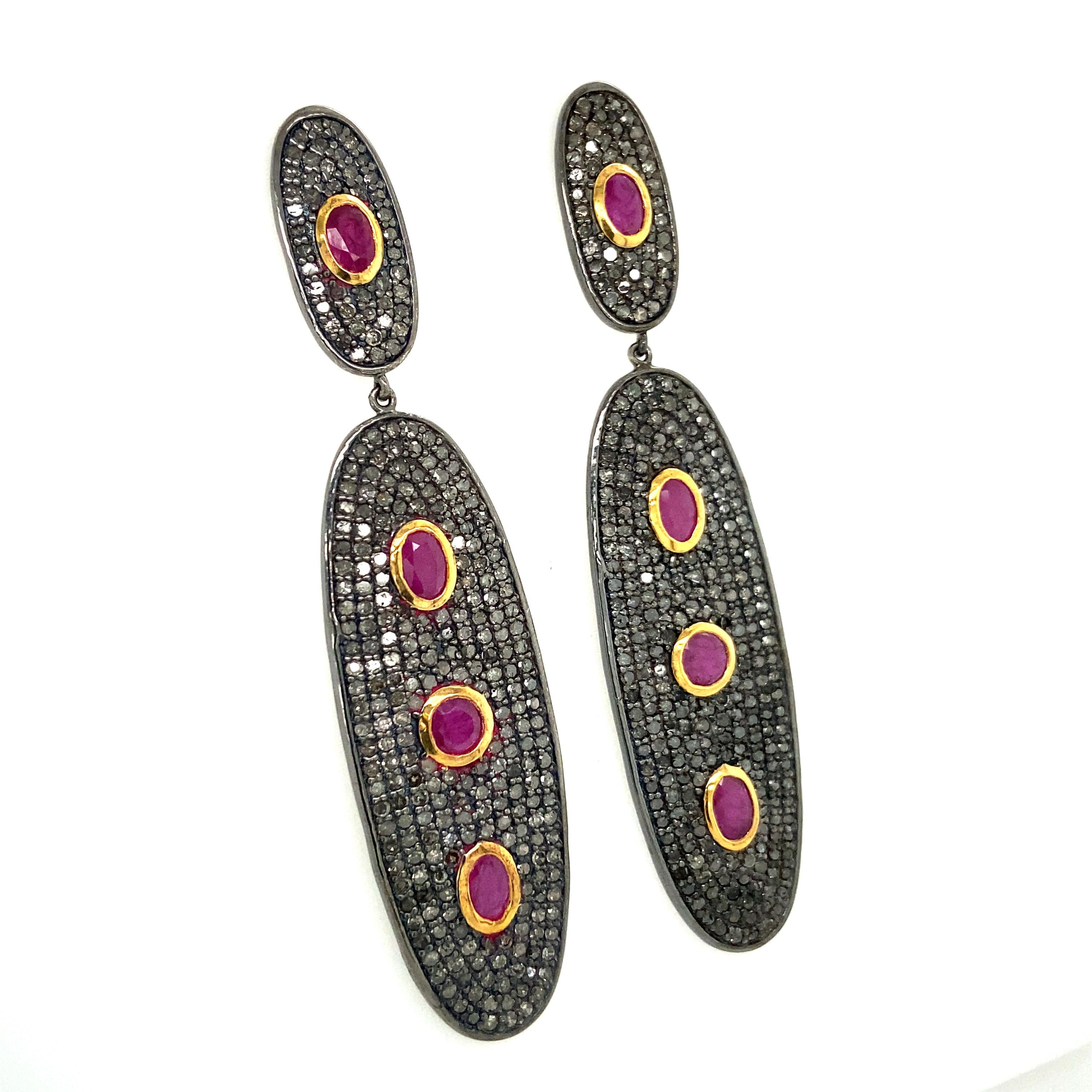 Life In Color Collection 

Eye catching Ruby drop earrings with Icy Diamond set in blackened sterling silver and 14K gold plating.

Ruby: 12.94ct total weight.
Diamond: 3.40ct total weight
