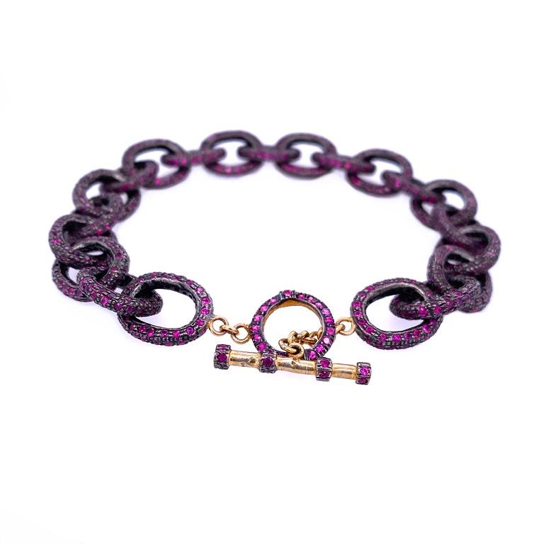 Life In Color Collection 

Rough chic Ruby chain link bracelet with toggle clasp. Set in sterling silver and 14K gold plating. 

Ruby: 15.36ct total weight. 
