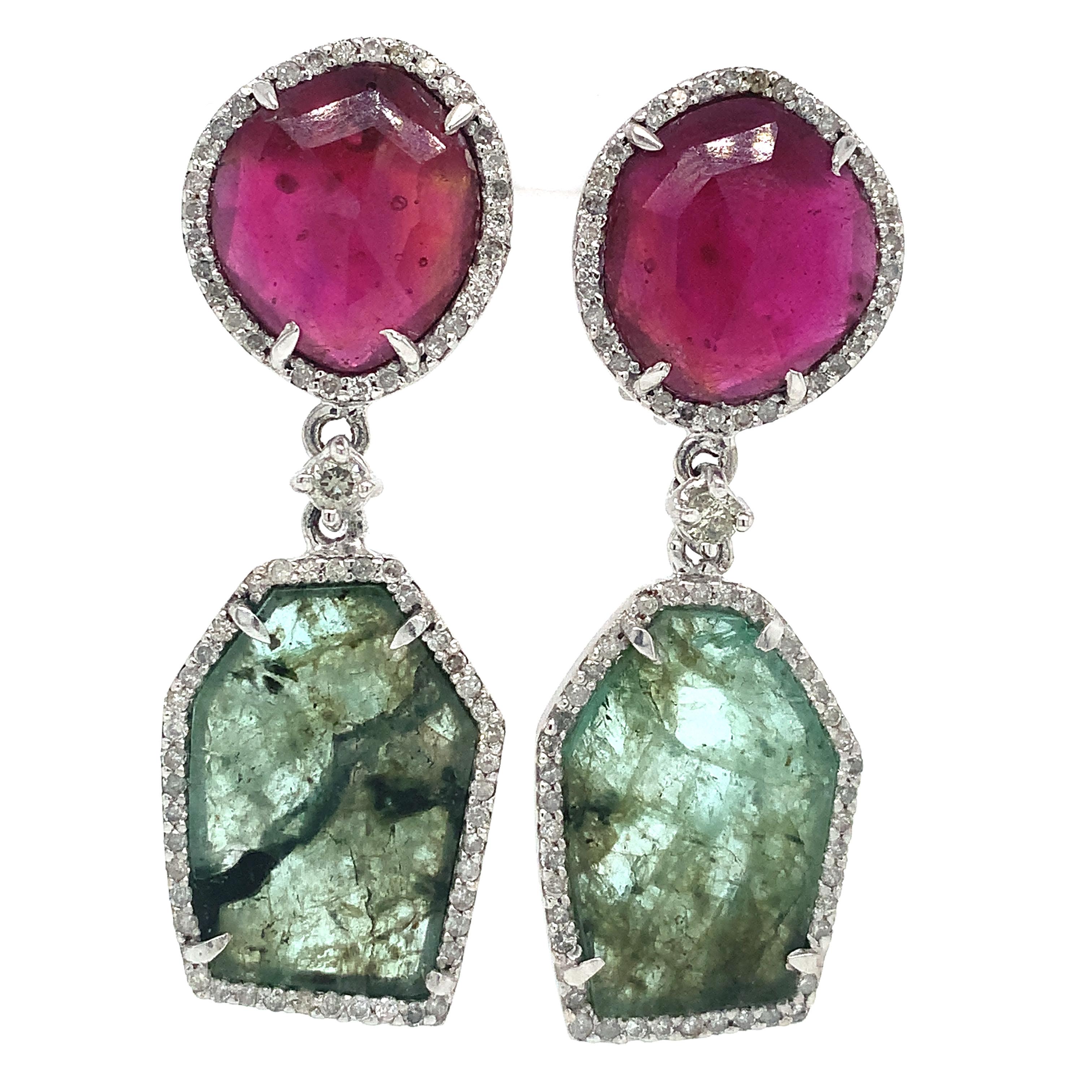 Ruby , Emerald with Diamonds all around in 18K white gold.

Ruby: 13.83ct total weight.
Emerald:9.73ct total weight.
Diamond:1.18ct total weight.
