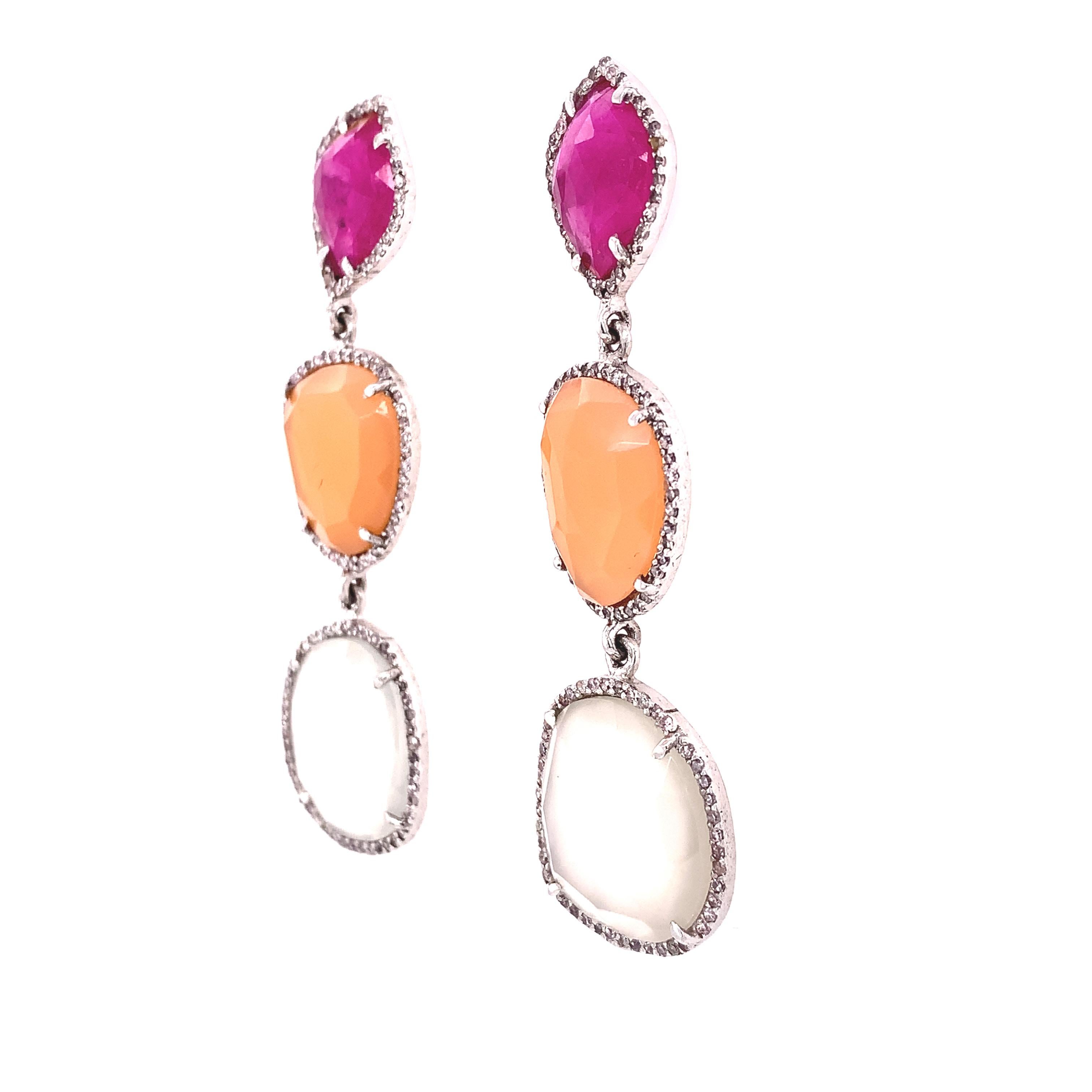Life In Color Collection 

Cute color combination of red with Moonstone earrings and Diamond accent set in sterling silver. 

Ruby: 5.45ct total weight
Moon stone: 25.66ct total weight
Diamond:  1.16ct total weight
 