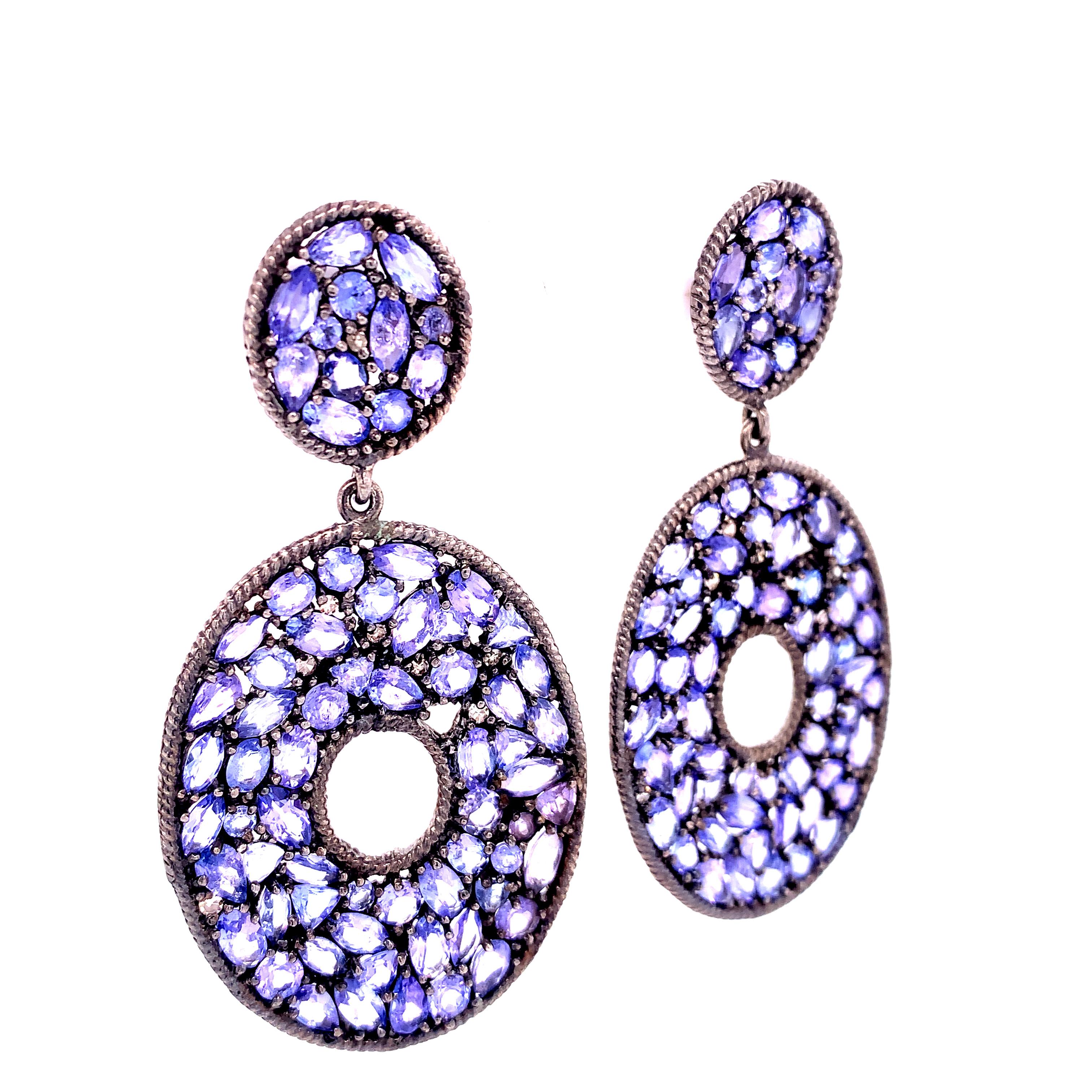 Jasmine Collection

Mix shape drop earrings featuring Tanzanite set in darkened sterling silver.

Tanzanite: 23.03ct total weight.
Diamond: 0.26ct total weight. 