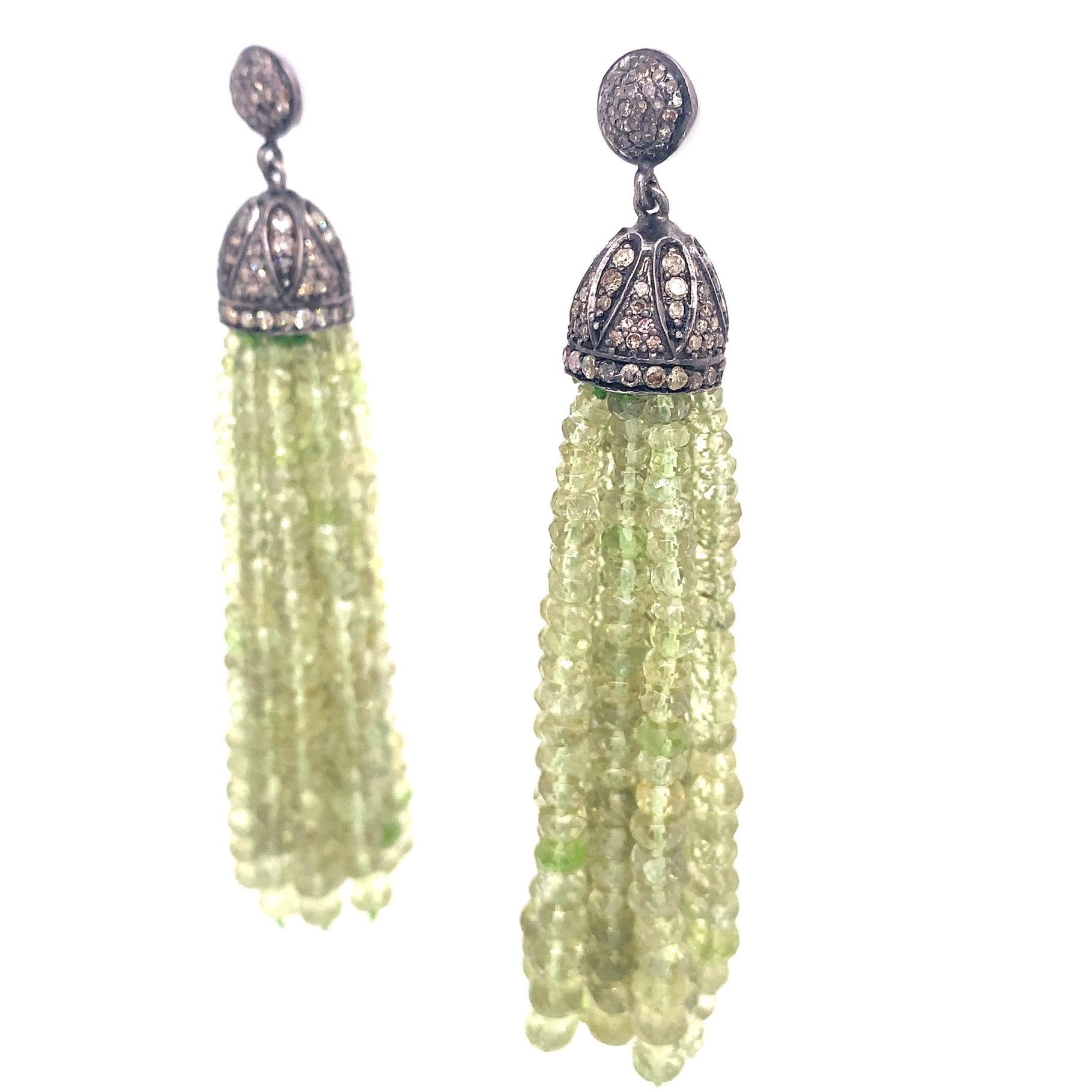 Life in Color Collection

Peridot beads featured tassel dangling from a bead cup set with Rustic Diamonds in Sterling Silver.

Peridot: 198.01ct total weight.
Diamond: 1.98ct total weight.