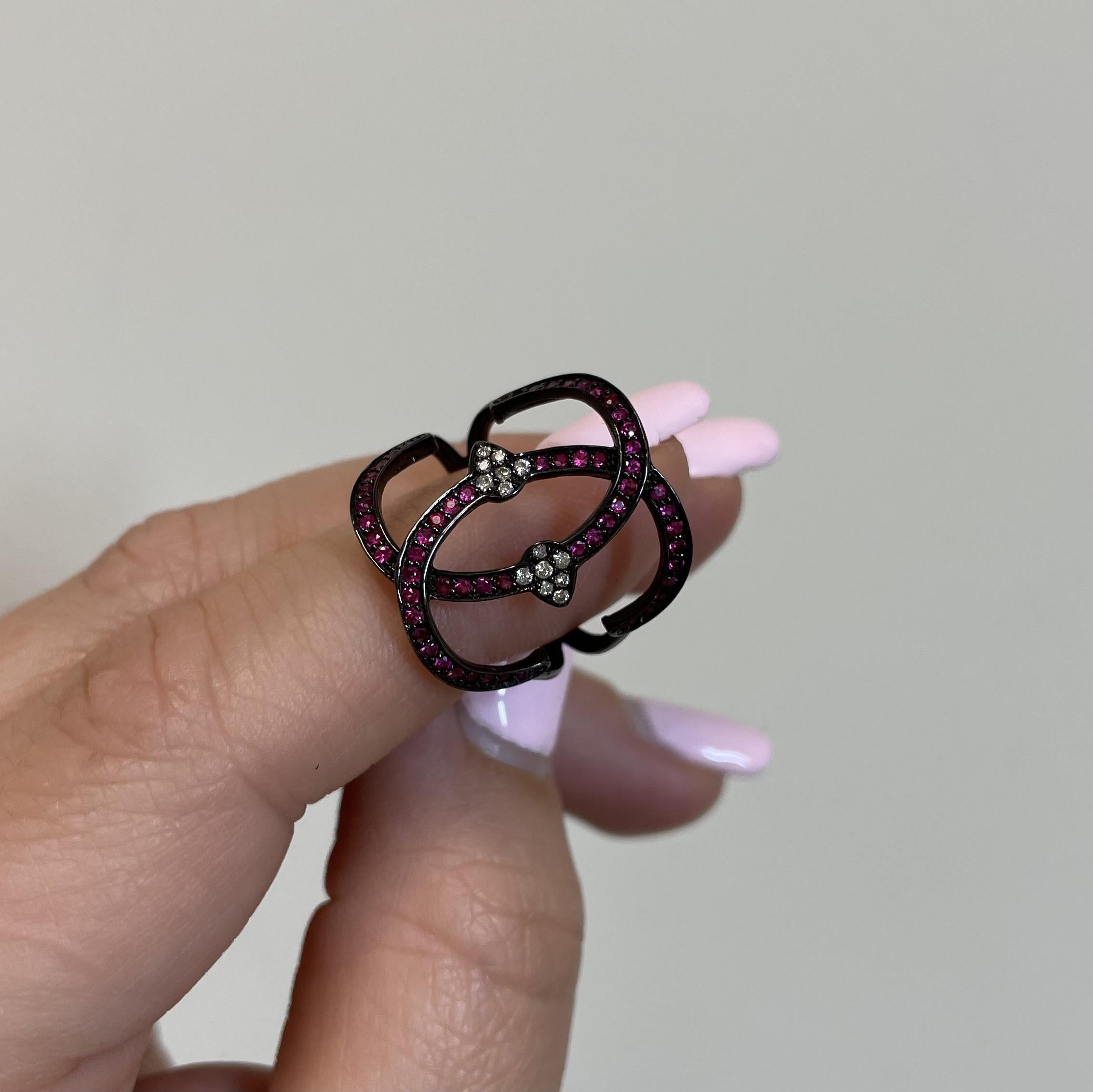 Experience the allure of modern elegance with our exquisite Ruby and Diamond Ring, crafted with precision and artistry.

This captivating piece, set in 18K gold with black rhodium accents, showcases the vibrant brilliance of 0.49 carats of red