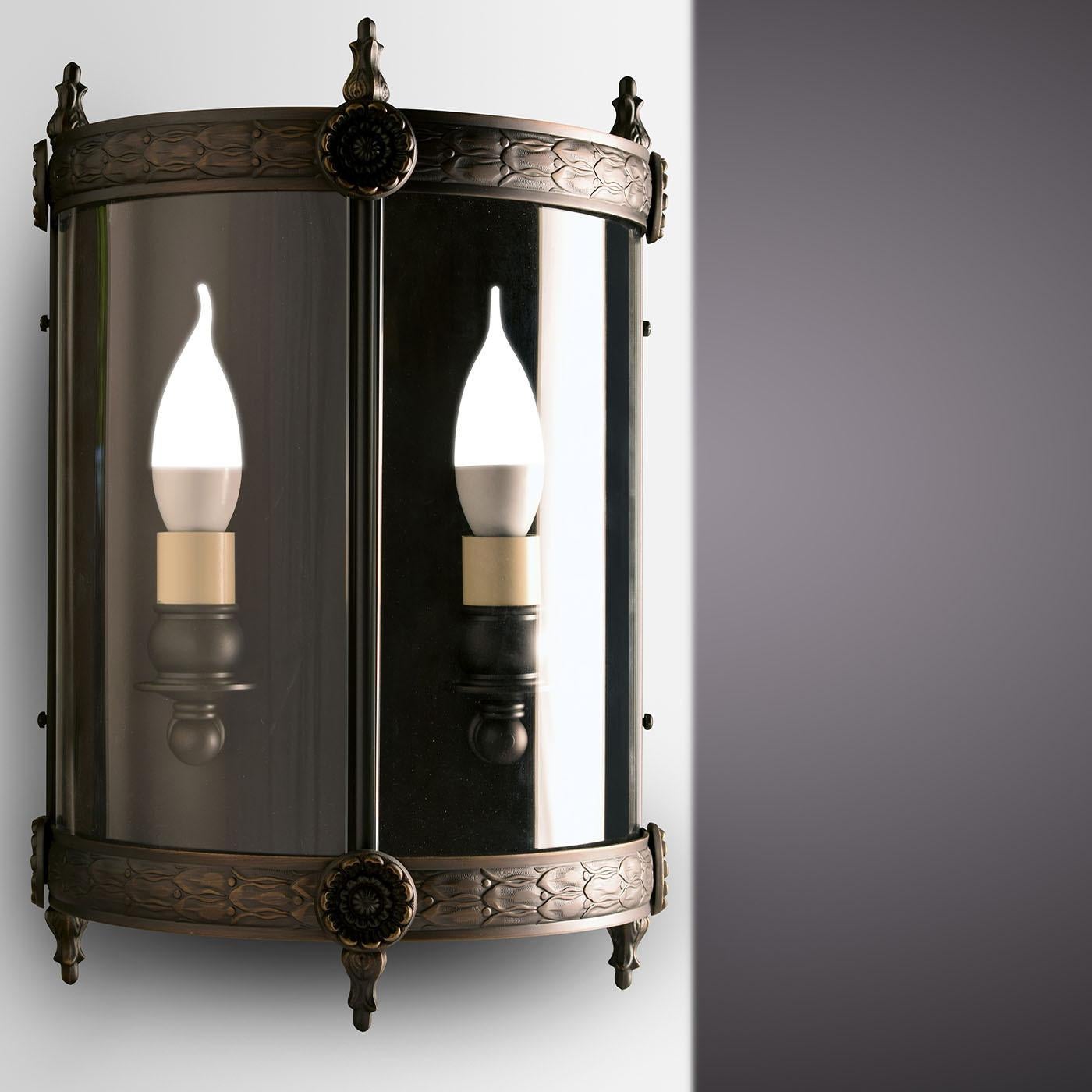 Part of the Lucerna Collection of brass lanterns distinguished by an unmistakable classic style and refined antiqued bronze-veil finish, this wall lamp makes for a superb addition to sophisticated traditional interiors. Minute chiseled detailing