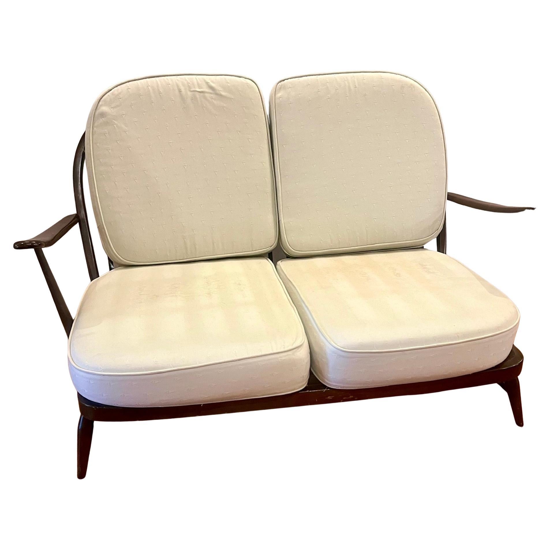  Lucian Randolph Ercolani designed “Windsor” setee for his company Ercol, England, circa 1950’s. Italian born Ercolani moved to the UK where he opened his own furniture company. His midcentury modern take of the classic English Windsor chair is