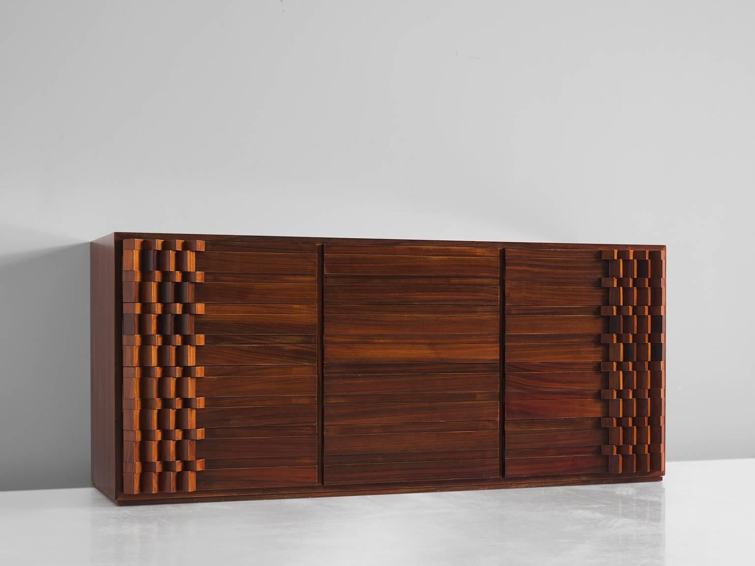 Luciano Frigerio cabinet rosewood, Italy, 1970s.

This Postmodern credenza is designed with a complex 3D pattern of squares that create a wonderful play of shadow and light on each corner of the sideboard. The 'blocks' create a strong graphic and