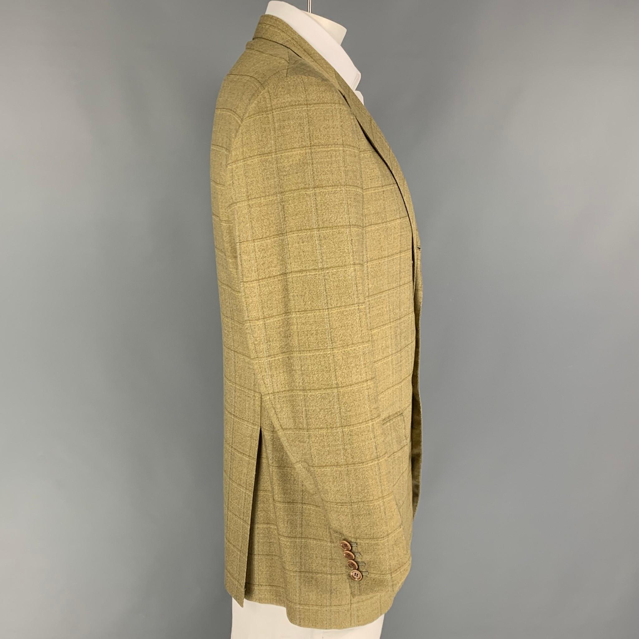 LUCIANO BARBERA sport coat comes in a yellow & olive window pane wool with a full liner featuring a notch lapel, flap pockets, double back vent, and a three button closure. Made in Italy. 

Very Good Pre-Owned Condition.
Marked:
