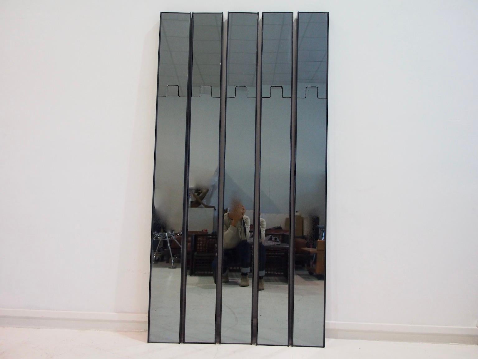 Five modular “Gronda” coat hanger wall mirrors with black plastic frame, designed by Luciano Bertoncini and manufactured by Elco in the 1970s. The upper parts of the modules can be pushed back which turns them into coat hangers. 
Dimensions for each