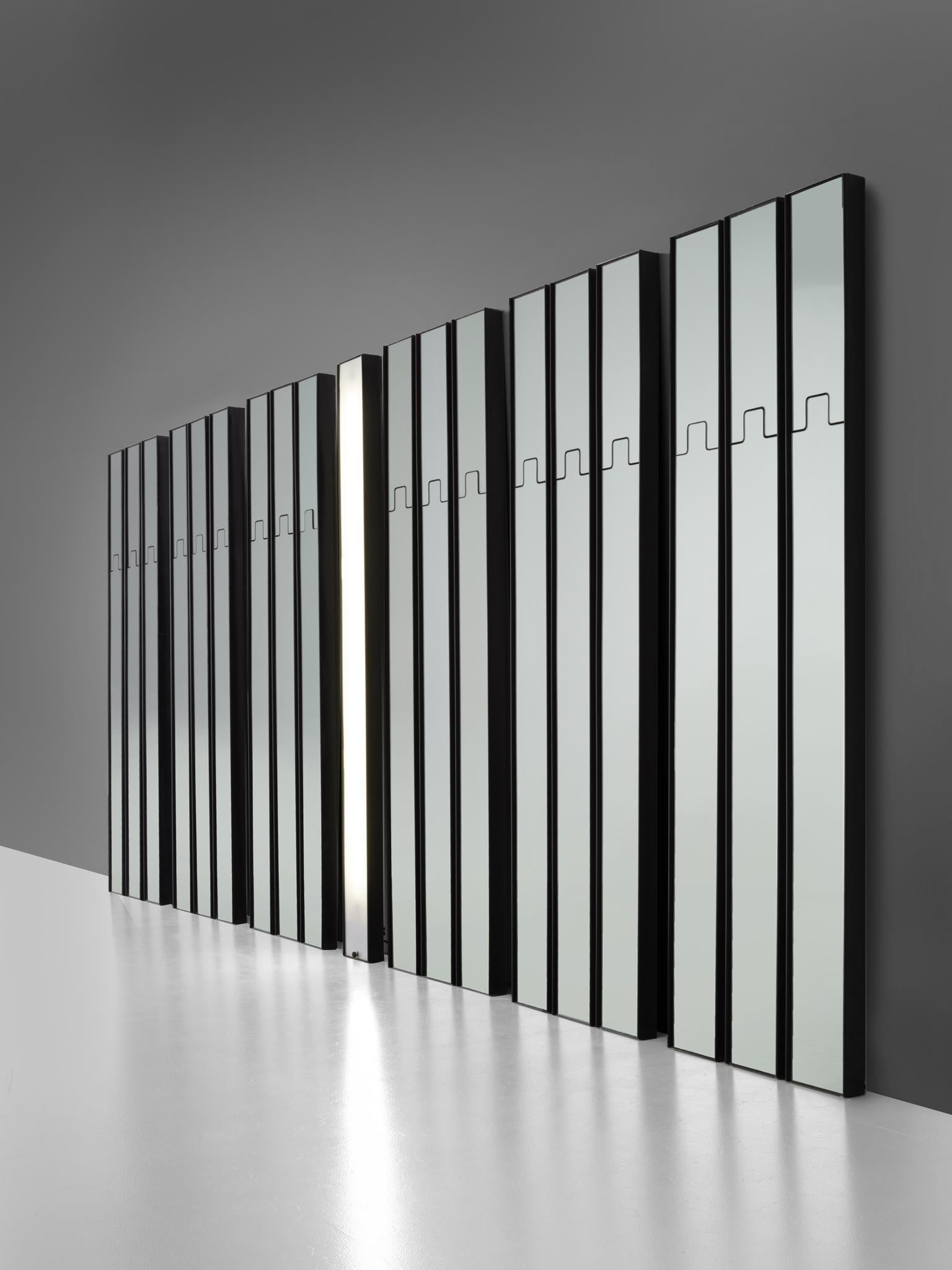 Luciano Bertoncini for Elco, mirror wall elements, black plastic and mirror, Italy, 1970.

This very large collection of wall elements are designed by Luciano Bertoncini. The elements consists of 18 wall-mounted pieces of which 17 mirrors and one