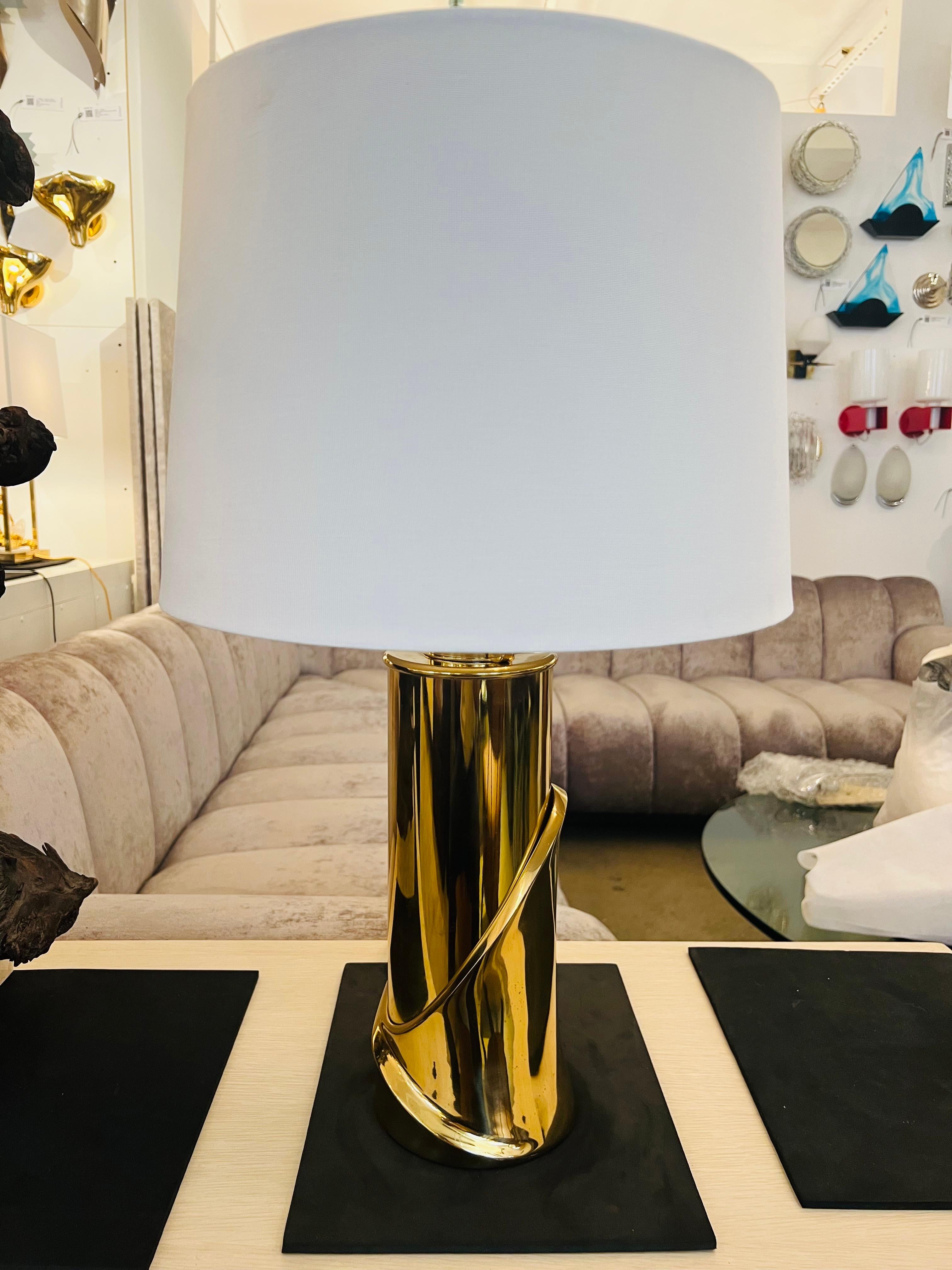 A polished bronze sculptural table lamp with a polished brass sockets by Luciano Frigerio. Newly rewired.