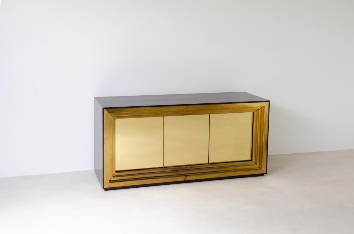 Luciano Frigerio (1928-1999)
Large and unique storage unit with three-door front made of solid brass with shaped brass frame. Dark wood structure.
Manufactured by Frigerio & circa 1970s.
Original brand of the manufacture.