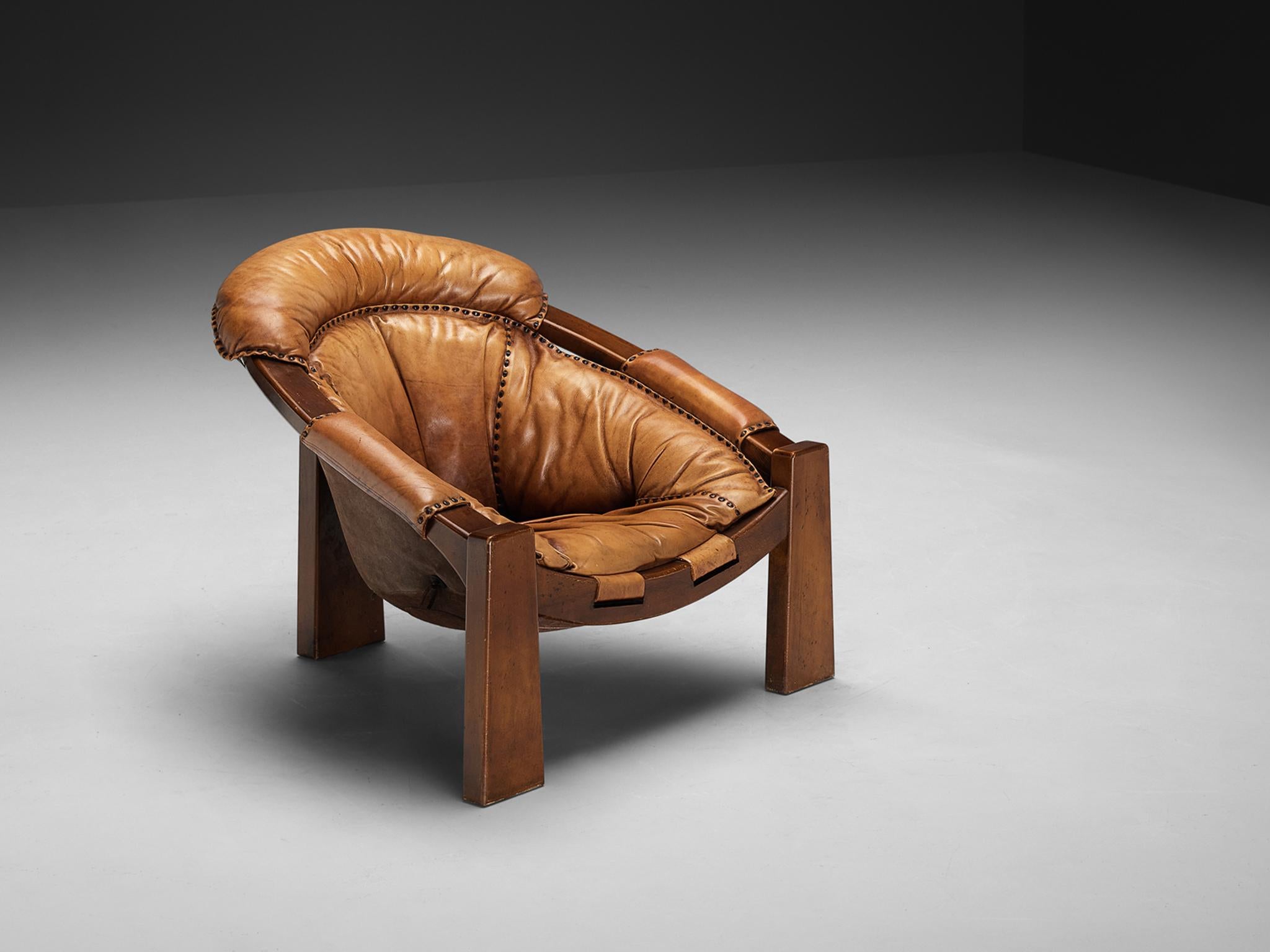 Luciano Frigerio, armchair, leather, stained wood, Italy, 1970s

 A captivating armchair by the esteemed Italian designer Luciano Frigerio, skillfully crafted during the 1970s. This monumental lounge chair, beckoning with unparalleled comfort,