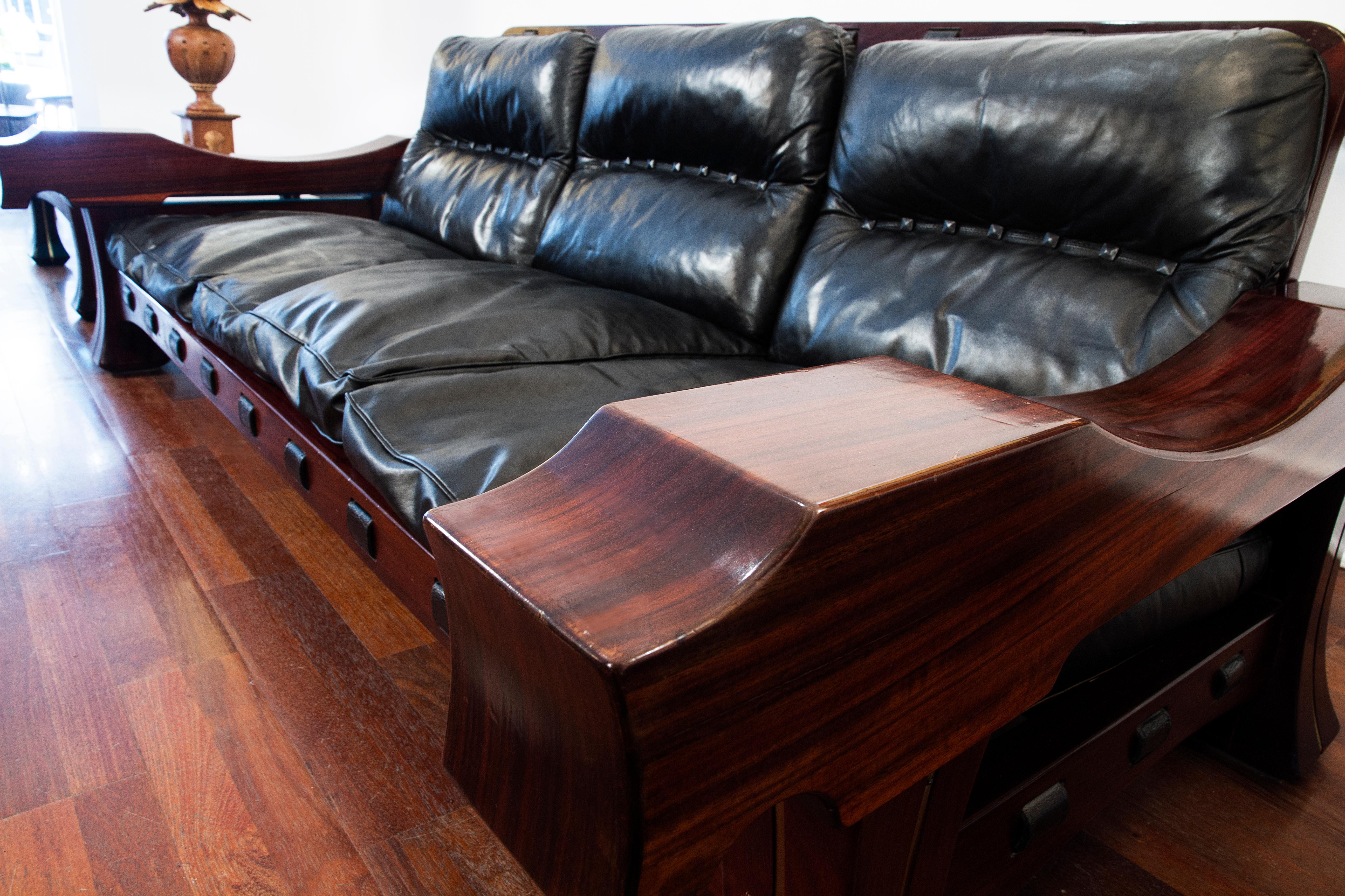 This is a very rare Luciano Frigerio mahogany sofa from the late 1960s, inlaid with brass, which really accentuates the wood. Original leather black cushions that they are supported by heavy leather belt straps with metal buckles. The sofa is in