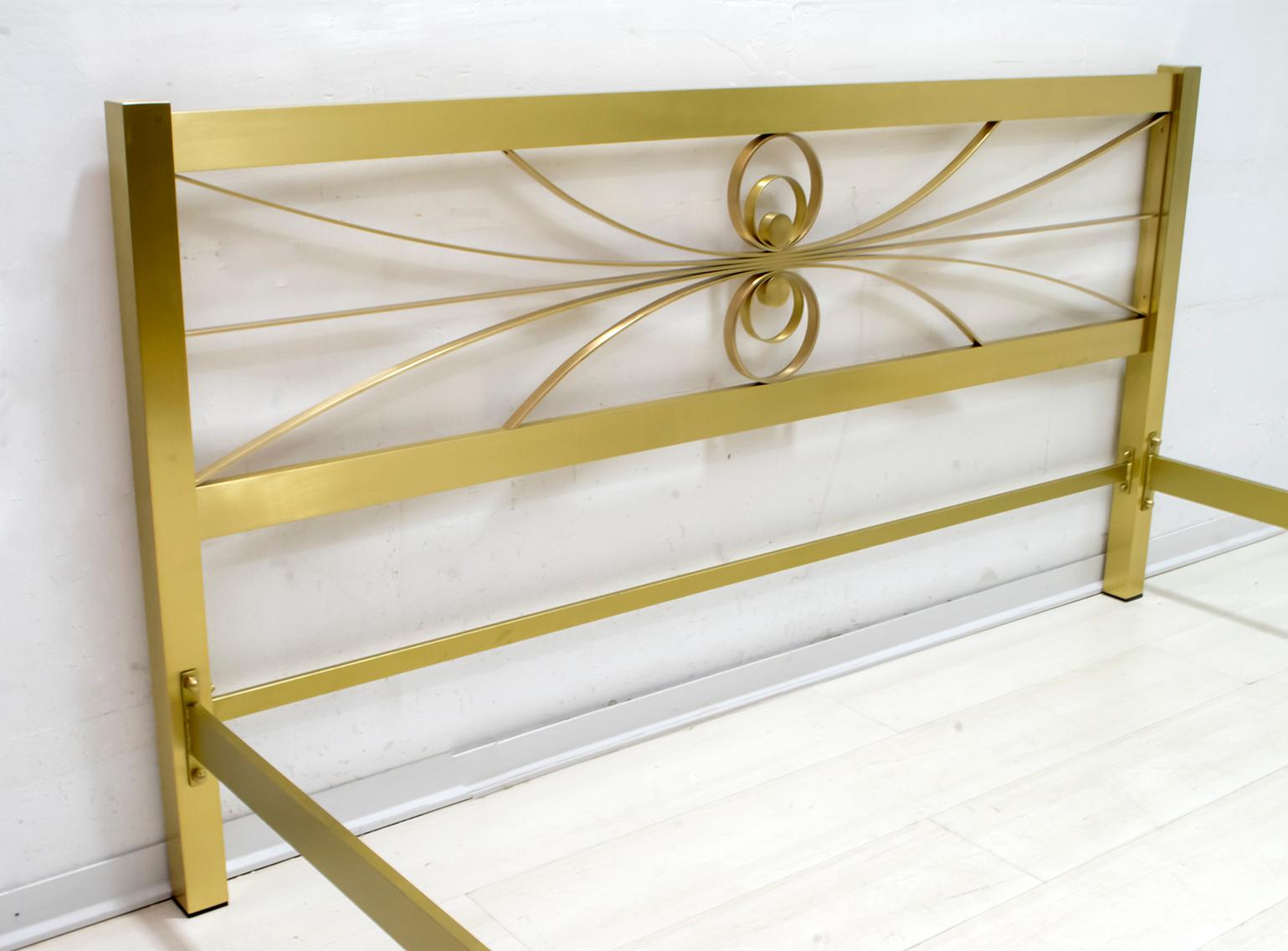 Elegant double bed designed by Luciano Frigerio, Italy, 1970s, in good original condition, bed kept in a warehouse of a furniture factory. The decorative section includes metal crosspieces with a gold finish.
