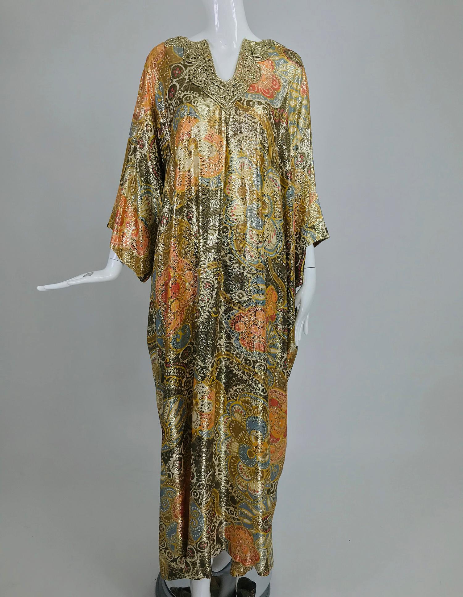 Lucie Ann metallic gold brocade full length caftan from the 1970s. This gorgeous caftan in made from a gold metallic brocade that is woven through a silky floral pattern that has the colours of autumn, large floral motifs are shot through with gold,