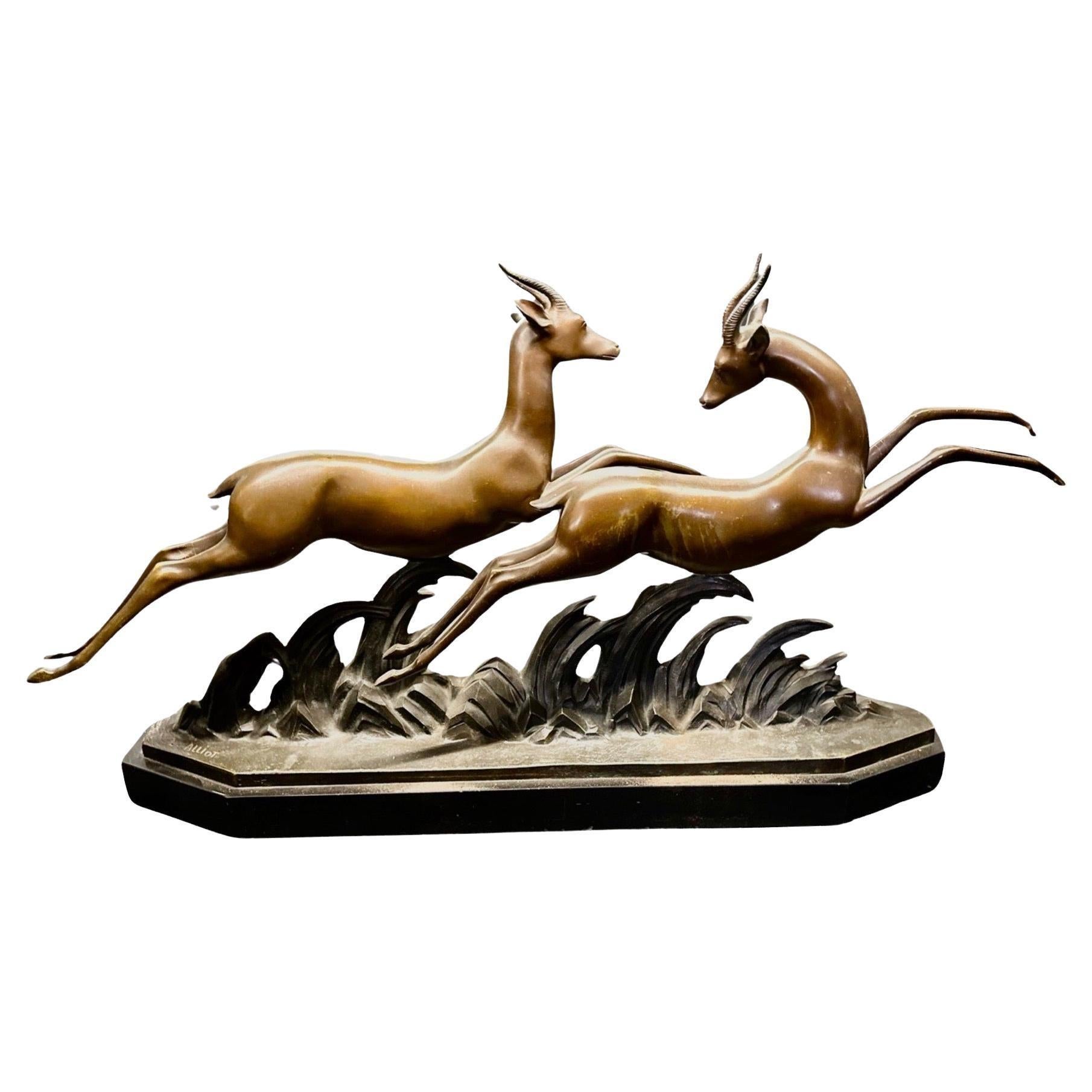 Lucien Alliot French Art Deco Bronze The Gazelles 1930. The brown patina on a marble base signed on the bronze L Alliot and stamped bronze on the deer. This particular piece has exceptional rhythm where the two gazelles interplay in a movement