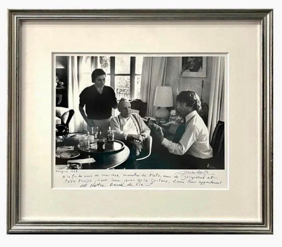 Lucien Clergue (FRENCH, 1934 - 2014) 
Gelatin silver photographic print depicting Pablo Picasso titled "Mougins".
Jacqueline et Pablo Picasso écoutant Manitas de Plata, circa 1968.
Hand signed by the artist with hand written description. Titled and