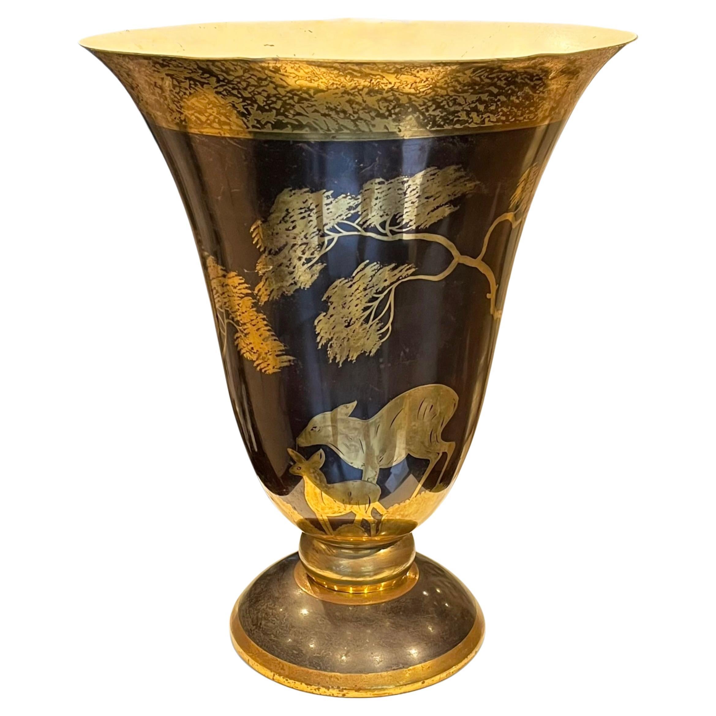 A 1930's dinanderie lamp by French designer Lucien Gerfaux, featuring a forest scene with two deers