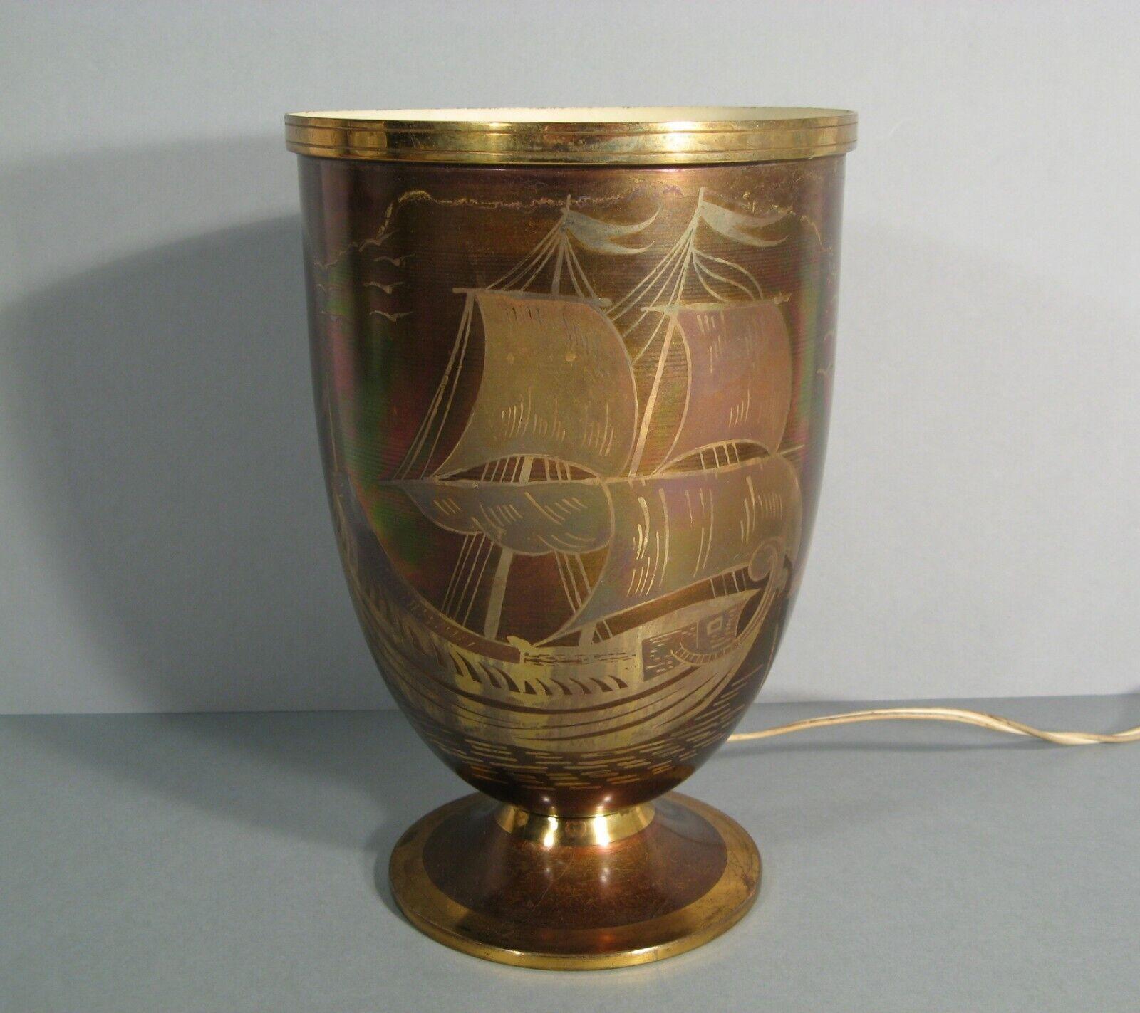 An elegant Art Deco lamp by Lucien Gerfaux, featuring a design of a boat on a coastal landscape, crafted from copper and brass dinanderie.

Product Details:

Type: Lamp
Material: Copper and Brass Dinanderie
Design: Boat with coastal