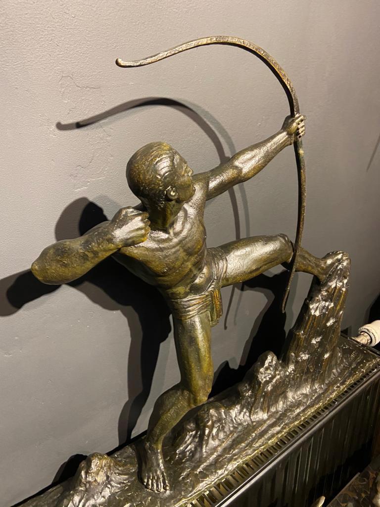 Master sculptor Lucien Gilbert's famous “The Archer” sculpture embraces the finest in French bronze detailing of the period. The size, quality, and weight of this piece are impressive. The verdigris patina has a unique character, and the textured