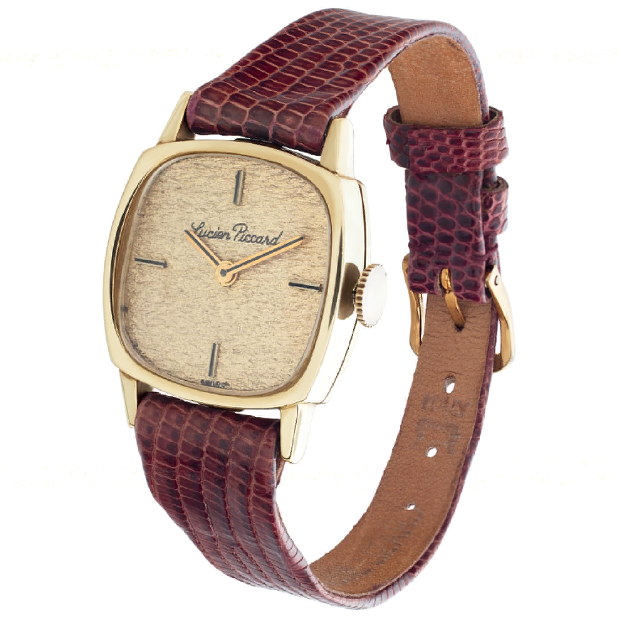 Vintage Lucien Picard in 14k with a gold colored textured bark dial set with applied stick markers on a lizard  band with a gold fill tang buckle. Circa 1930s. Fine Pre-owned Lucien Picard Watch. Certified preowned Vintage Lucien Picard Vintage