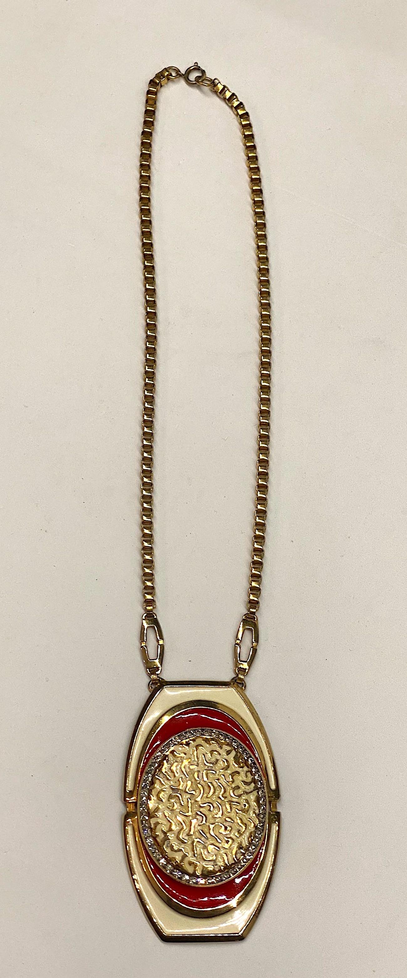 Lucien Piccard 1970s enamel and gold tone pendant necklace. A large cast pendant 2.13 inches wide and 3.5 inches long is suspended from two .88 long oval links and a thick box link chain. The pendant is enameled in an off white and red enamel. The