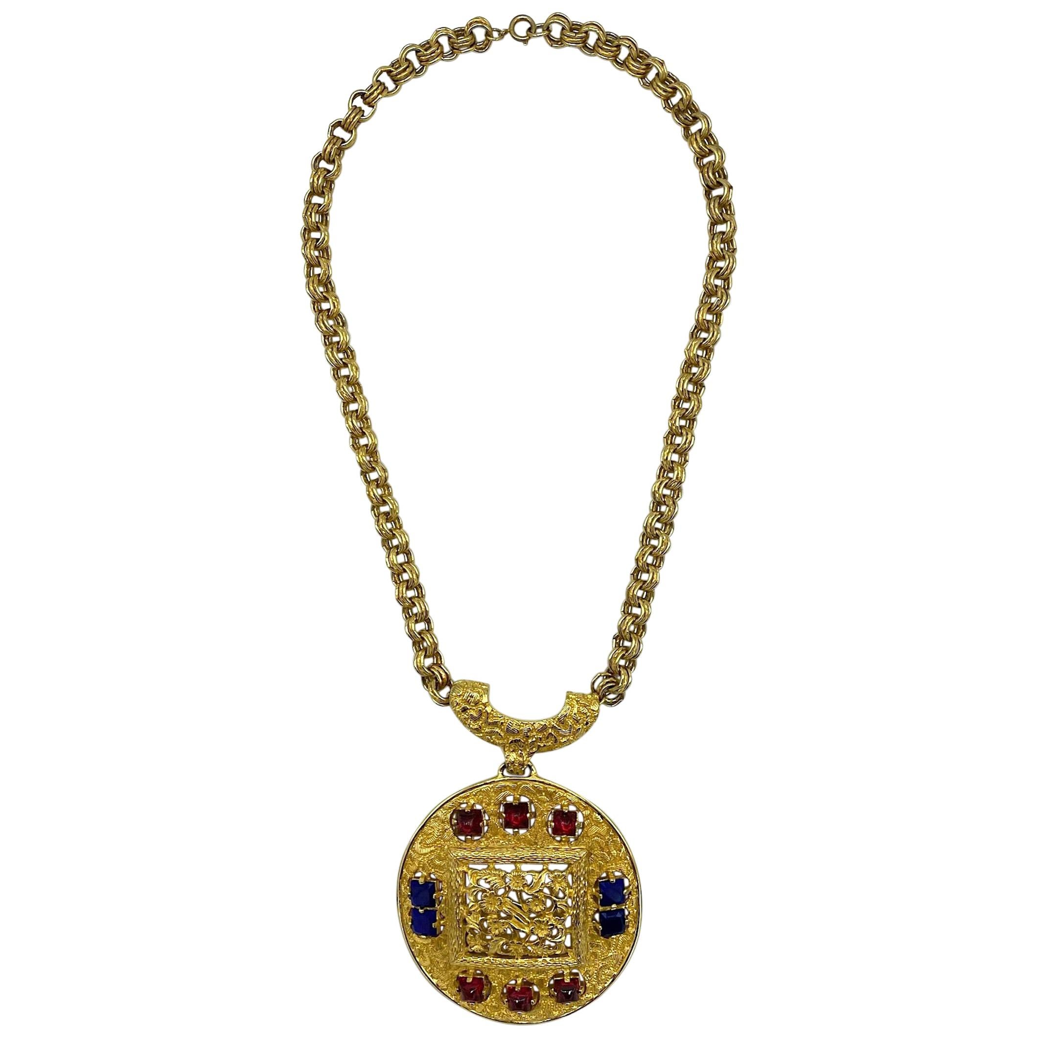 A beautiful and rare design Lucien Piccard pendant necklace in gold plate and set with glass jewels. Two ten inch double ring link strands meet at a Y shape top of the pendant. Suspended from this is a large 3.13 inch diameter round pendant. The