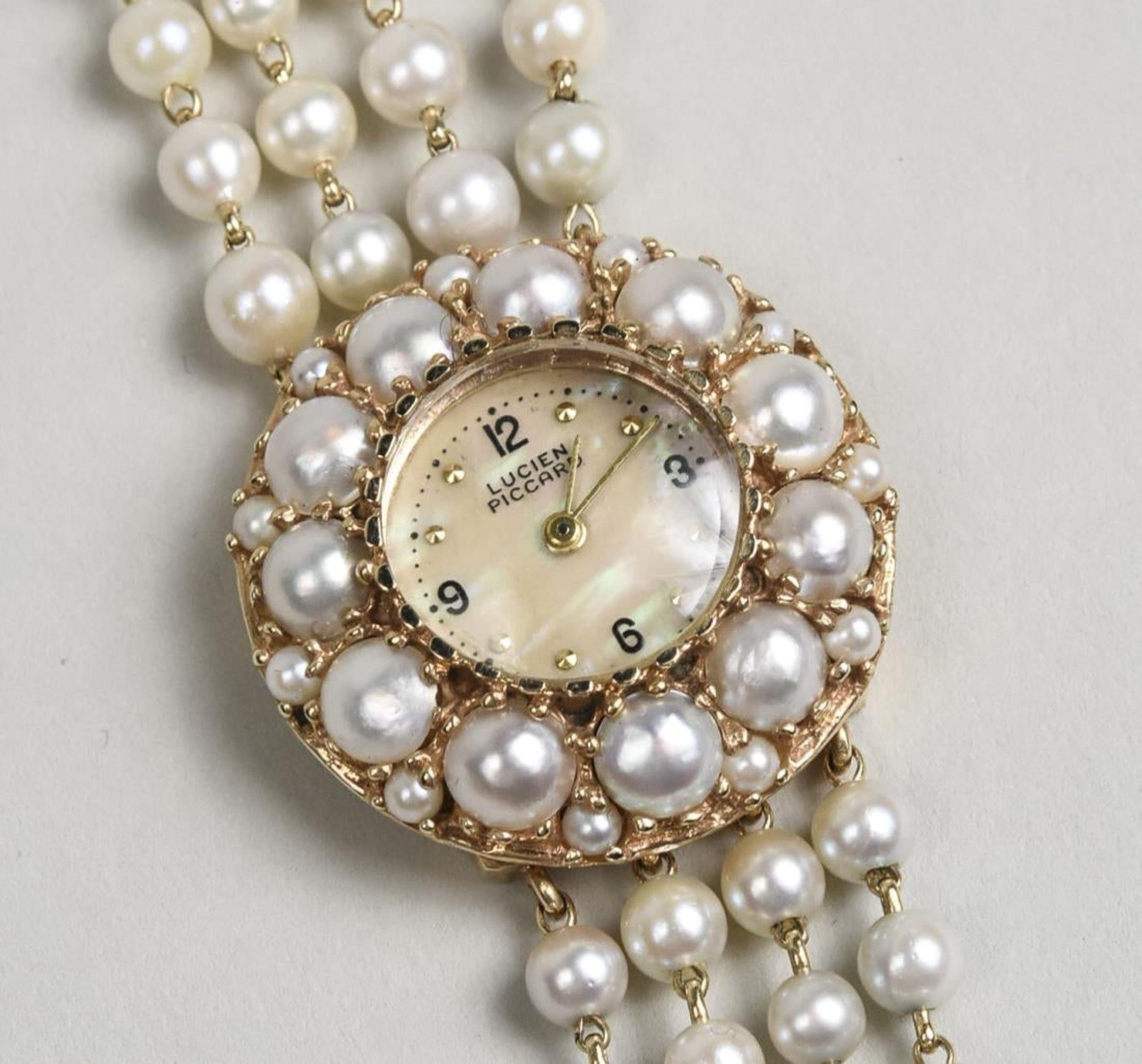 14k yellow gold watch with a round dial with Arabic quarter hours, within a border of pearls, four strand pearl band.  Length 6 inches.
