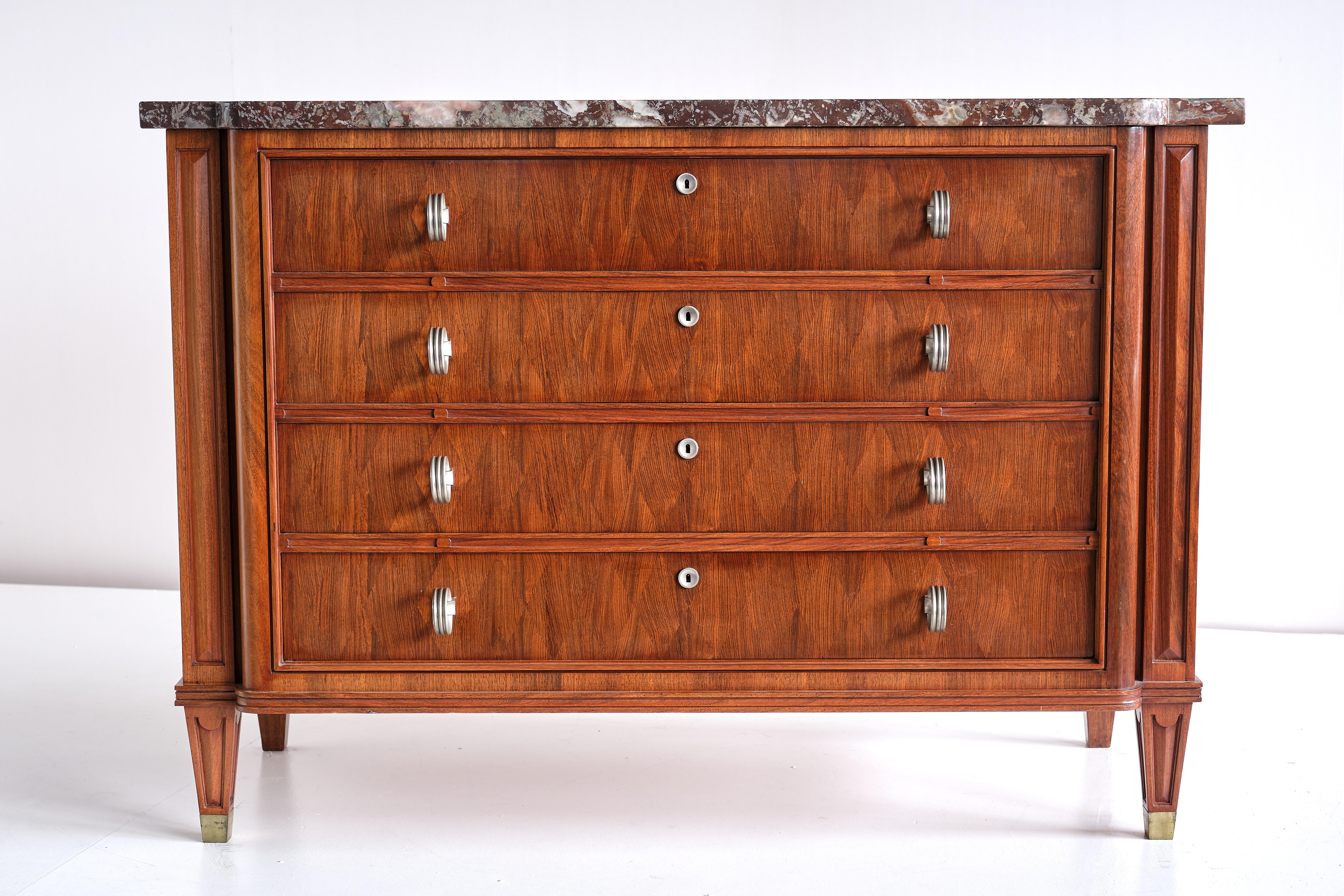 This exceptionally rare commode was designed by Lucien Rollin and produced in France in November 1945. The commode consists of four drawers mounted with brushed metal escutcheons and circular protruding handles. The drawers are executed in a