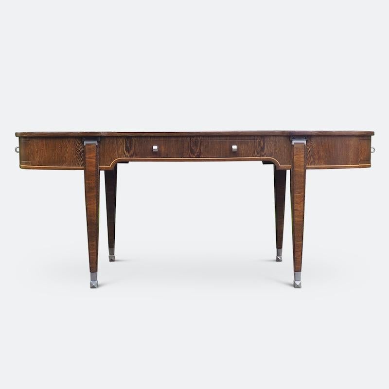 Lucien Rollin Elysée writing desk by William Switzer
Designed by Lucien Rollin and produced by cabinetmaker William Switzer. This grand writing desk is finished in Zebra wood and has a cream leather insert with a gold colored diamond cross-banded
