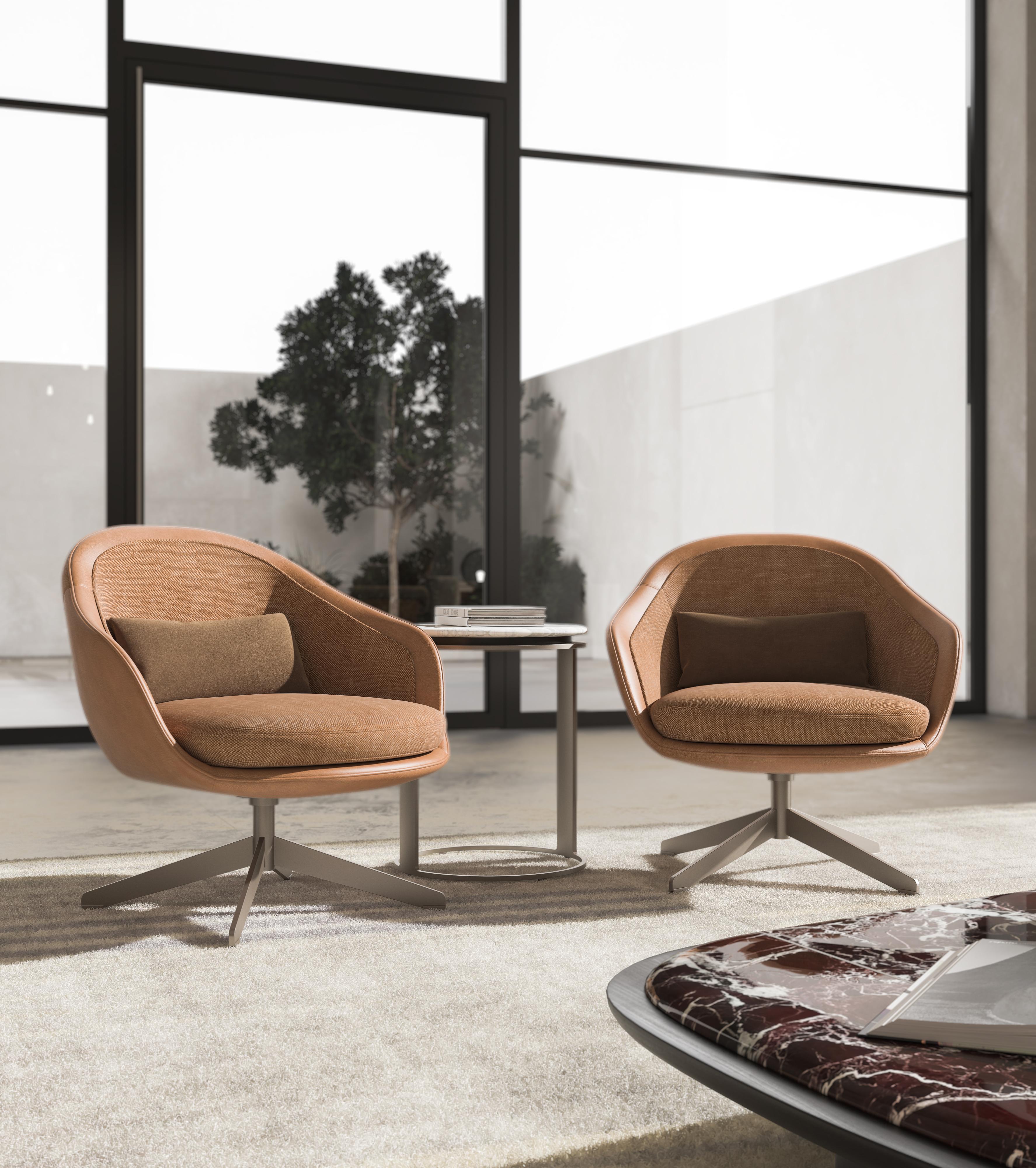 Este sillón cuenta con una elegante base metálica combinada con una tapicería a elegir de lujosa piel o tela de alta calidad, que ofrece comodidad y estilo. La base metálica proporciona una base contemporánea y resistente, mientras que la suave