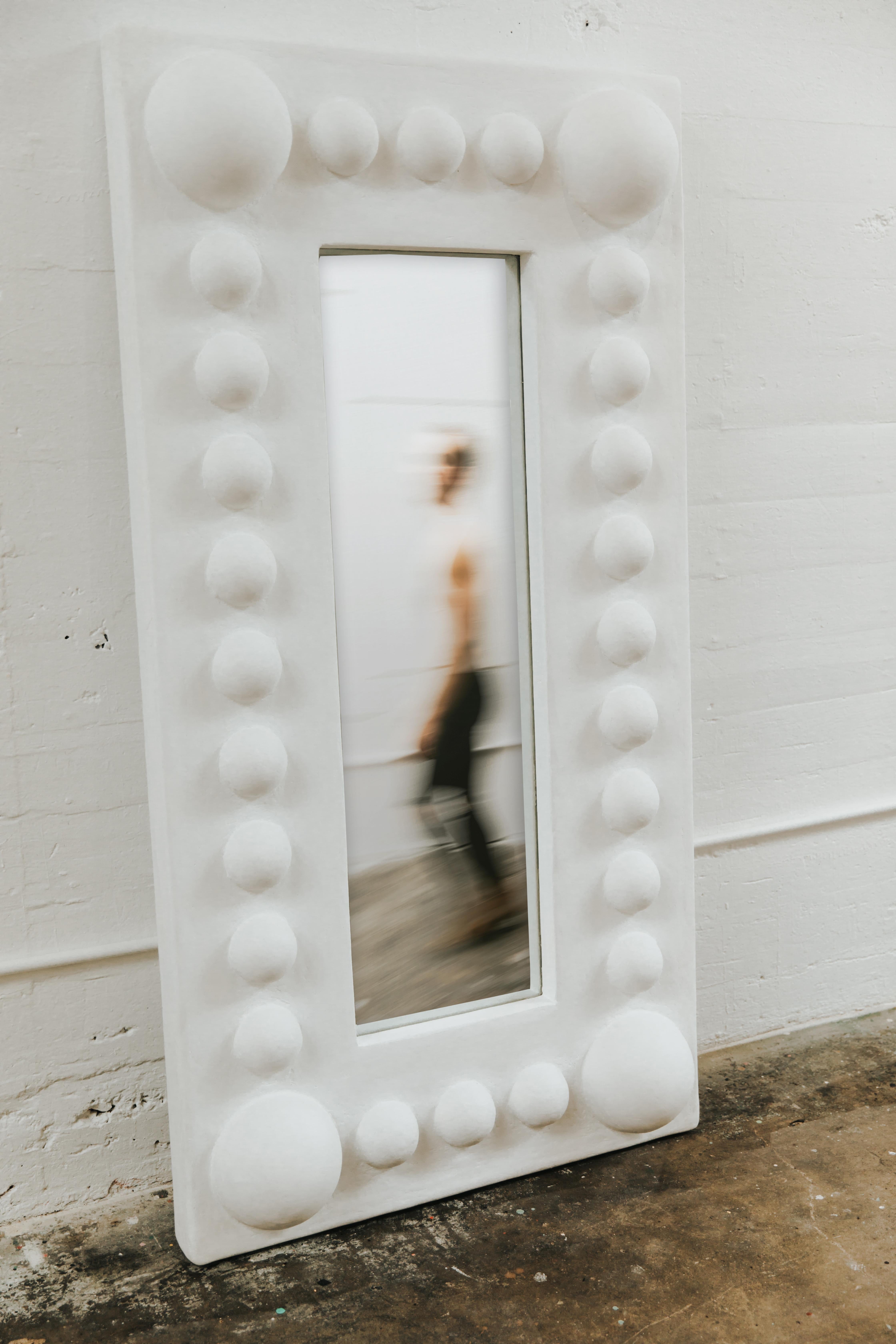 Crafted by hand, the Lucille Floor Mirror is a playful and demure piece that challenges modern clean lines and ordinary structure commonly seen on floor mirrors.

A simple form inspired by classic shapes, the Lucille is made from a complex plaster