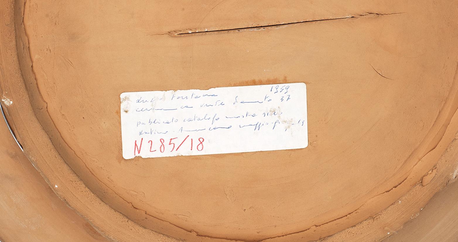 Concetto spaziale, Lucio Fontana, Unique, Postwar, terracotta, sculpture, 1950's

Painted terracotta, graffiti and cut
Signed and dated on the front : l.fontana / 59
Registered in the archives of Fondazione Lucio Fontana, Milano.

Provenance :