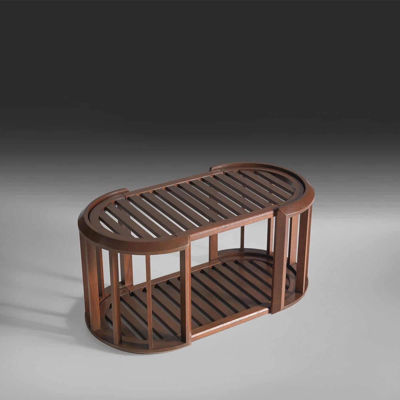 The Lucio coffee table crafted in iroko and designed for outdoor use, features a slatted top and bottom shelf that provide practical storage and display space. The structure is characterized by smooth rounded edges and vertical supports that