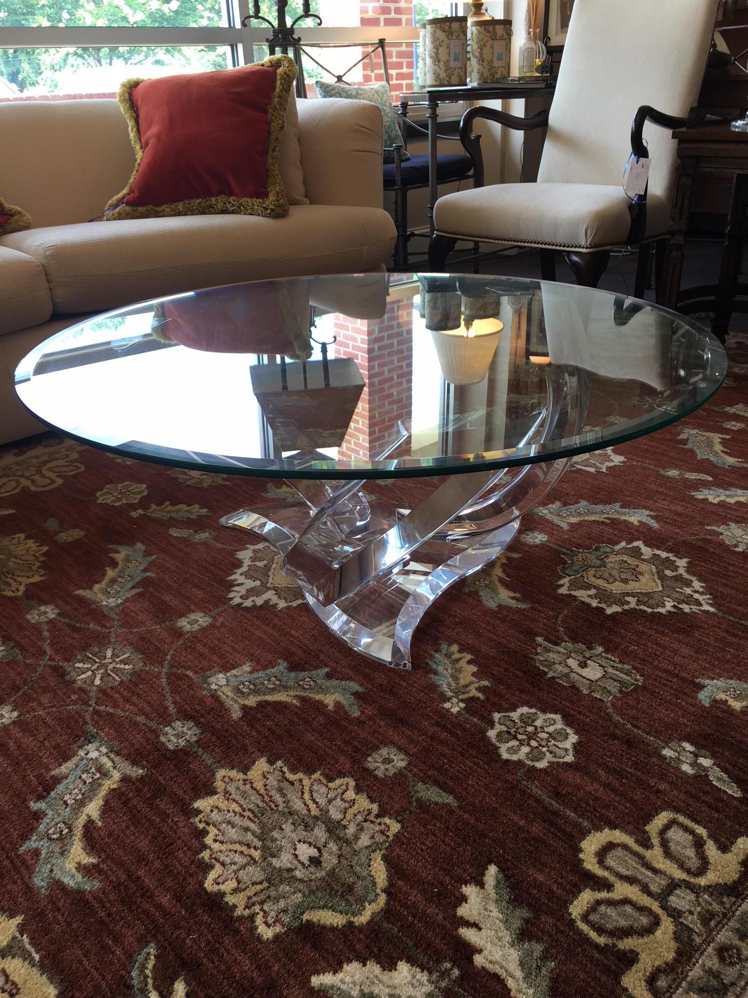 This vintage table hails from the mid-1990s and is in perfect condition. It has no signs of wear or use, and has no maker's mark. The base consists of three abstract shapes formed from Lucite; the top is bevelled glass. A great table.